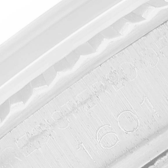 This close-up shot of the Rolex Vintage Collection 1601 Men's Stainless Steel Black Dial 1601 Men's Stainless Steel Black Dial watch shows the edge of the bezel and partially engraved serial number 1601.