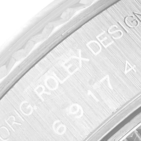 This close-up image shows the engraved text on the inner bezel of a Rolex Datejust 69174 Women's Stainless Steel Blue Dial 69174 Women's Stainless Steel Blue Dial watch.