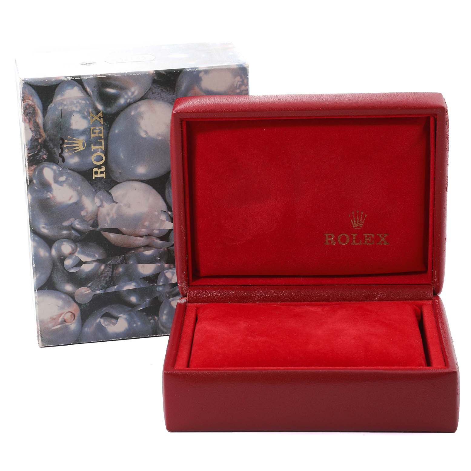 This image shows an open red Rolex Datejust 69174 Women's Stainless Steel Blue Dial 69174 Women's Stainless Steel Blue Dial watch box with the outer packaging behind it.