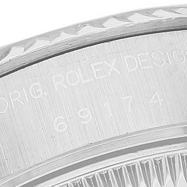 The image shows a close-up view of the engraving on a Rolex Datejust 69174 Women's Stainless Steel Silver Dial 69174 Women's Stainless Steel Silver Dial watch case.