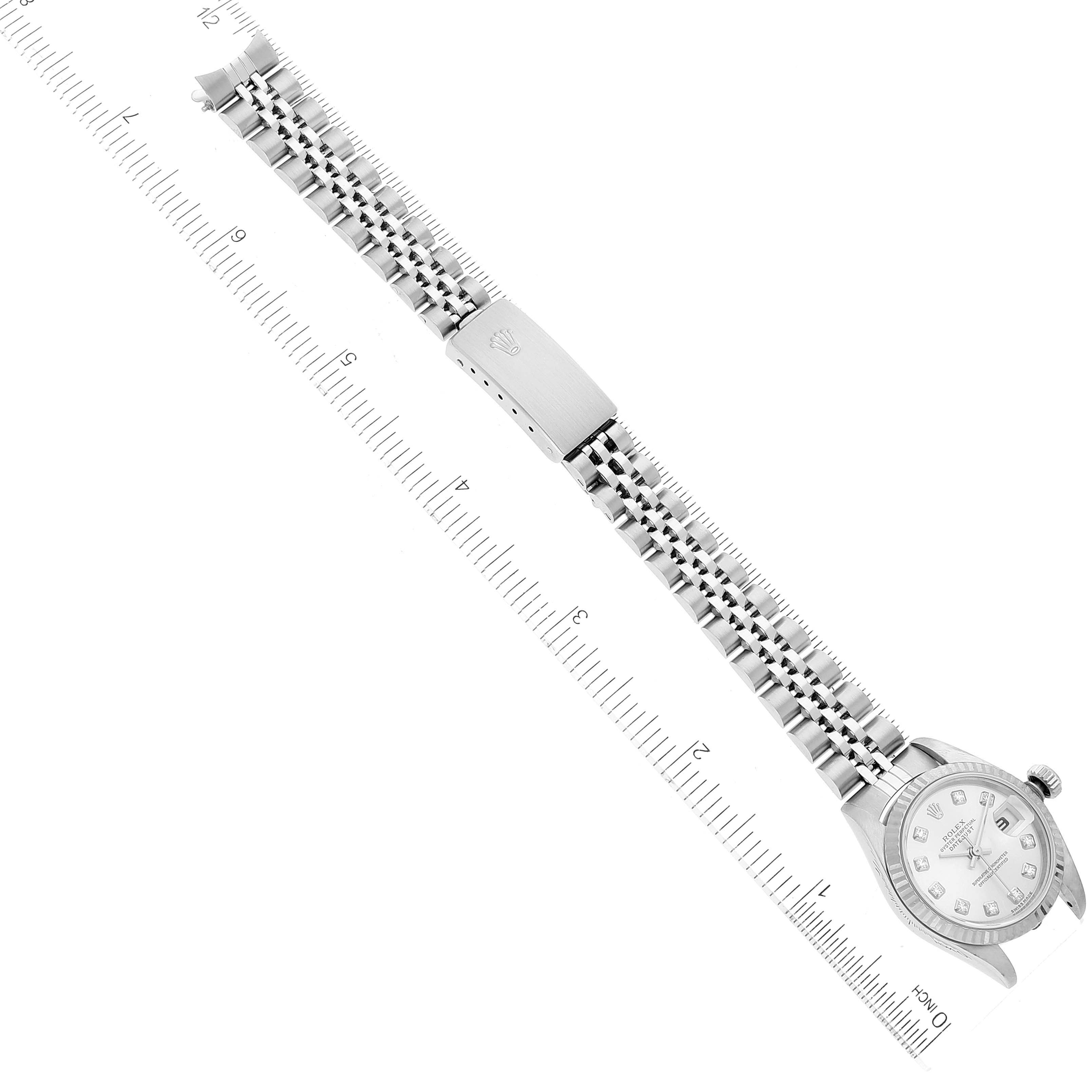 The image shows a Rolex Datejust 79174 Women's Stainless Steel Silver Dial 79174 Women's Stainless Steel Silver Dial watch laid flat with its entire bracelet and case visible next to a ruler for scale.
