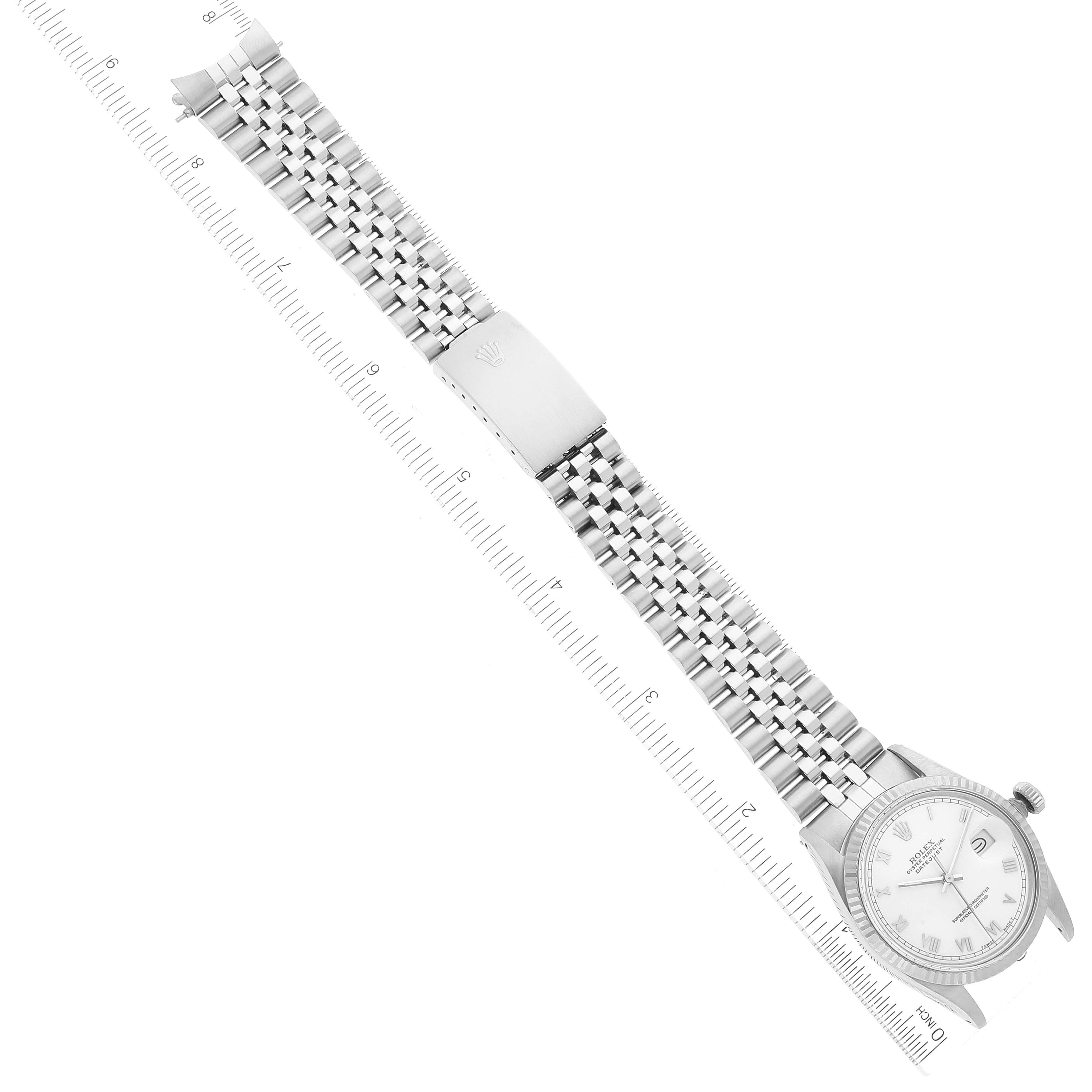 The image shows a Rolex Datejust 16014 Men's Stainless Steel White Dial 16014 Men's Stainless Steel White Dial watch and its bracelet, photographed from an overhead angle, including a ruler for scale.