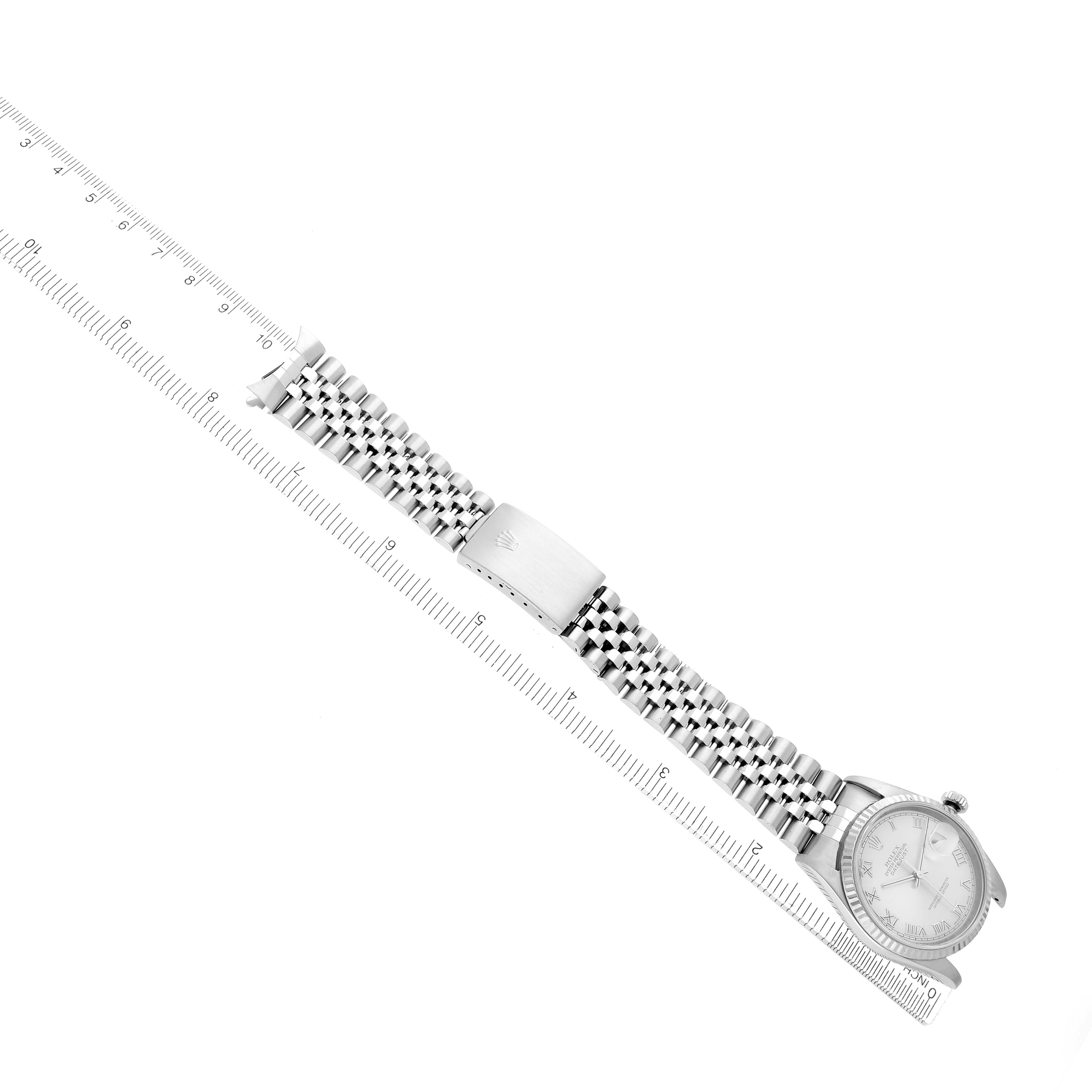 The Rolex Datejust 16234 Men
s Stainless Steel Silver Dial watch is shown from a top-down angle with its bracelet extended alongside a ruler.