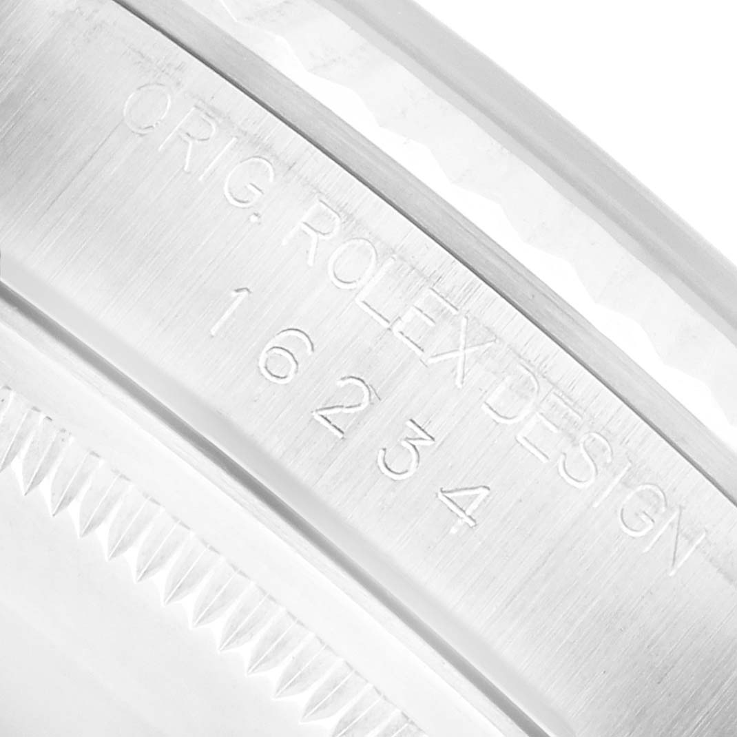 The image shows a close-up of the side engraving on a Rolex Datejust 16234 Men
s Stainless Steel Silver Dial, displaying the model number and design.