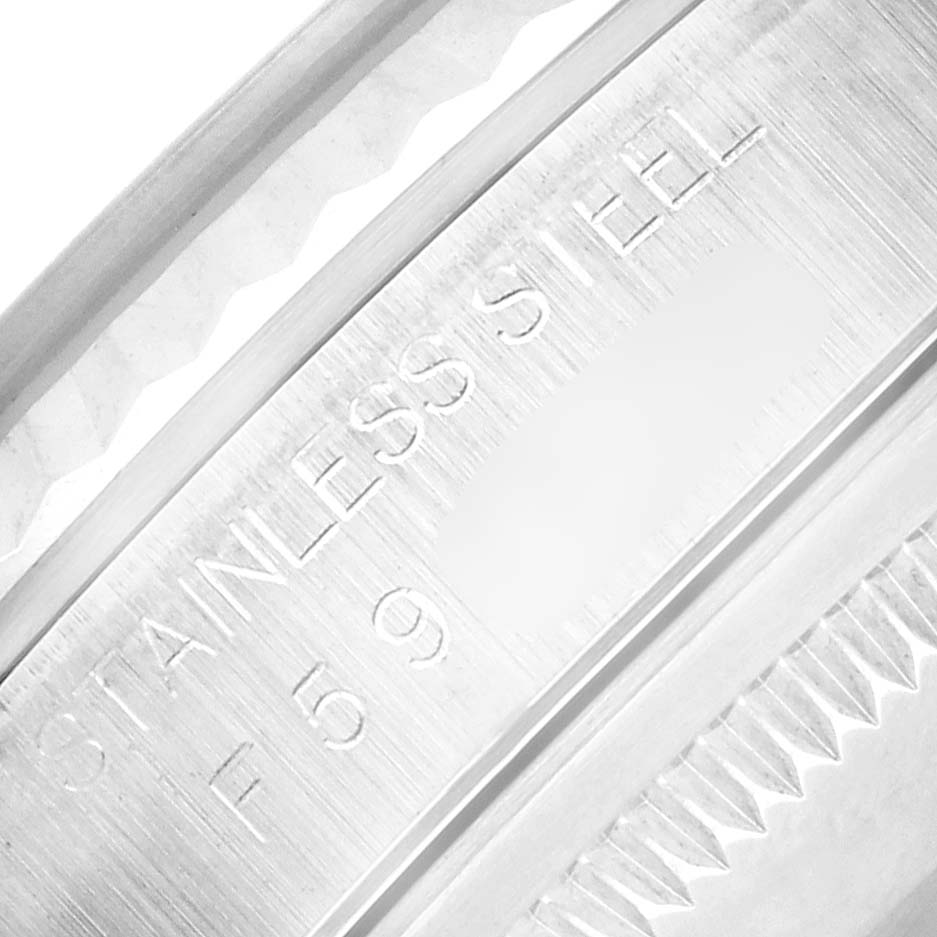 The image shows an extreme close-up of the side detailing and engravings on a Rolex Datejust 16234 Men
s Stainless Steel Silver Dial watch, highlighting "STAINLESS STEEL."