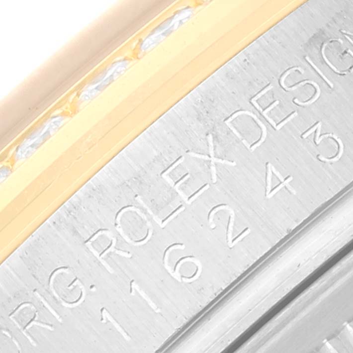 This image shows a close-up of the side of a Rolex Datejust 116243 Men's Steel and Gold (two tone) Black Dial 116243 Men's Steel and Gold (two tone) Black Dial watch, highlighting its engraved serial number and design detail.