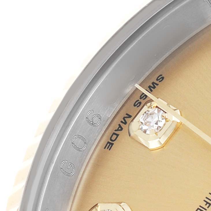 The image shows a close-up of the dial edge and a diamond marker of a Rolex Datejust 116233 Men's Steel and Gold (two tone) Champagne Dial watch.