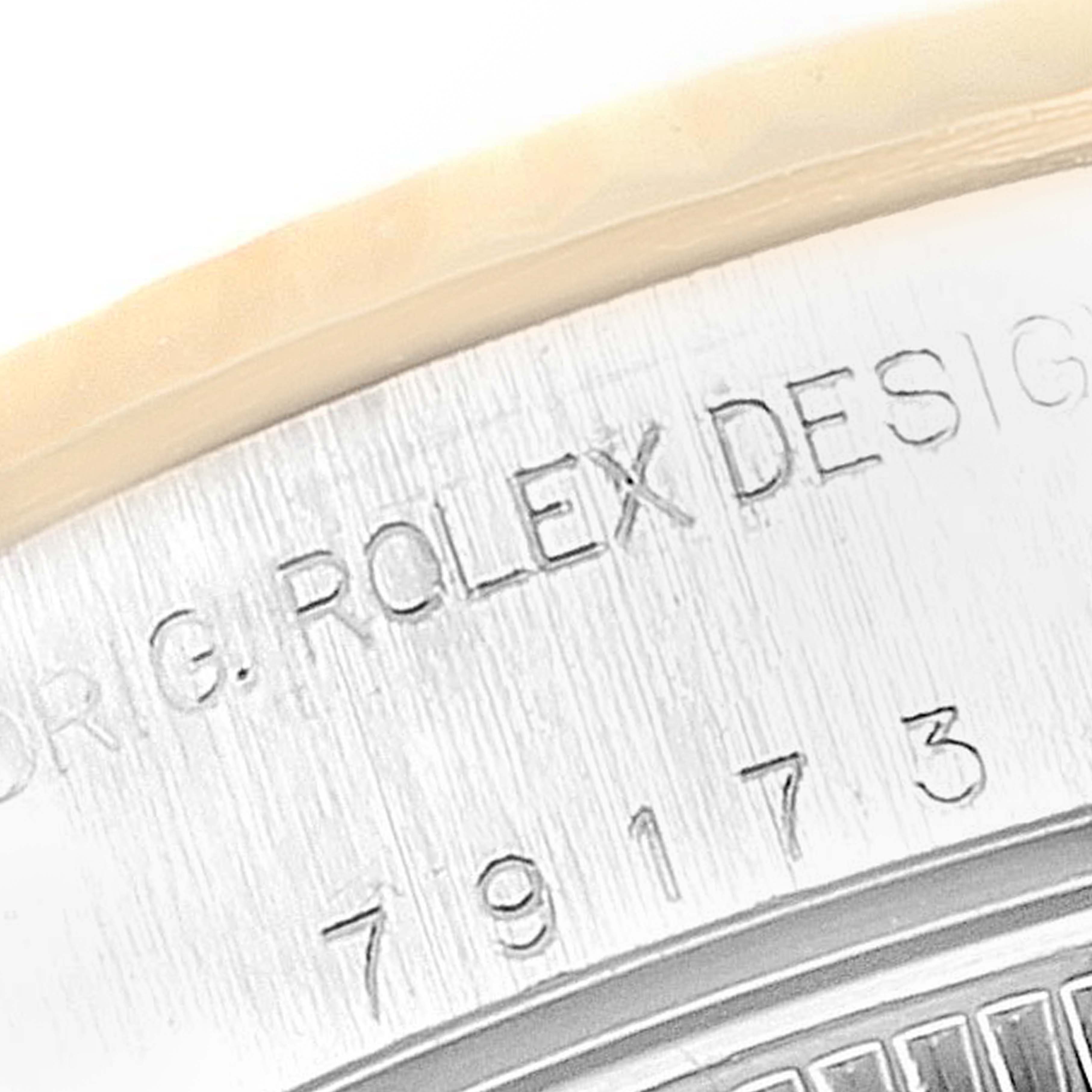 The image shows a close-up angle of the case back engraving on a Rolex Datejust 79173 Women
s Steel and Gold (two tone) Black Dial 79173 Women
s Steel and Gold (two tone) Black Dial watch.