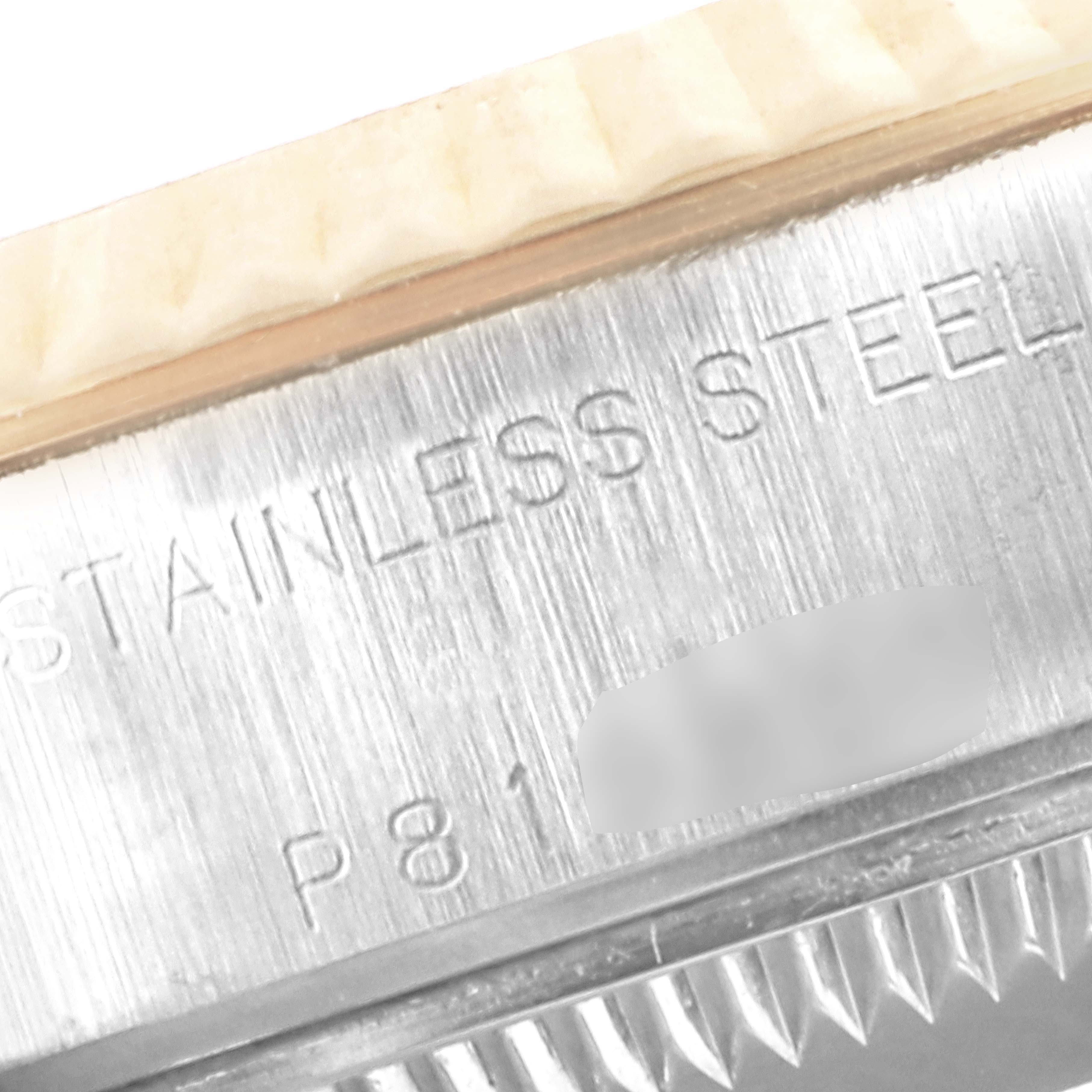 This close-up image shows the side view of the stainless steel case of a Rolex Datejust 79173 Women
s Steel and Gold (two tone) Black Dial 79173 Women
s Steel and Gold (two tone) Black Dial watch, highlighting the engraved text.