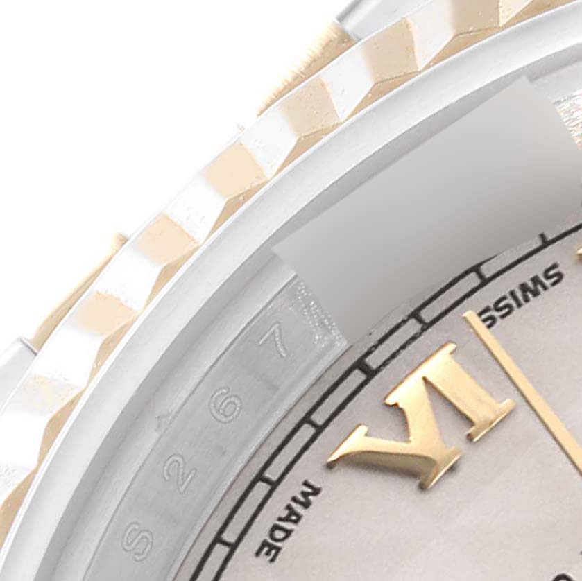 The image shows a close-up angle of a Rolex Datejust 179173 Women's Steel and Gold (two tone) Beige Dial 179173 Women's Steel and Gold (two tone) Beige Dial watch, highlighting its bezel, part of the dial, and numerals.