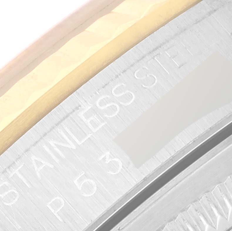 The image shows a close-up of the casing edge of a Rolex Datejust 16233 Men's Steel and Gold (two tone) Blue Dial 16233 Men's Steel and Gold (two tone) Blue Dial, highlighting "STAINLESS STEEL" engraving.