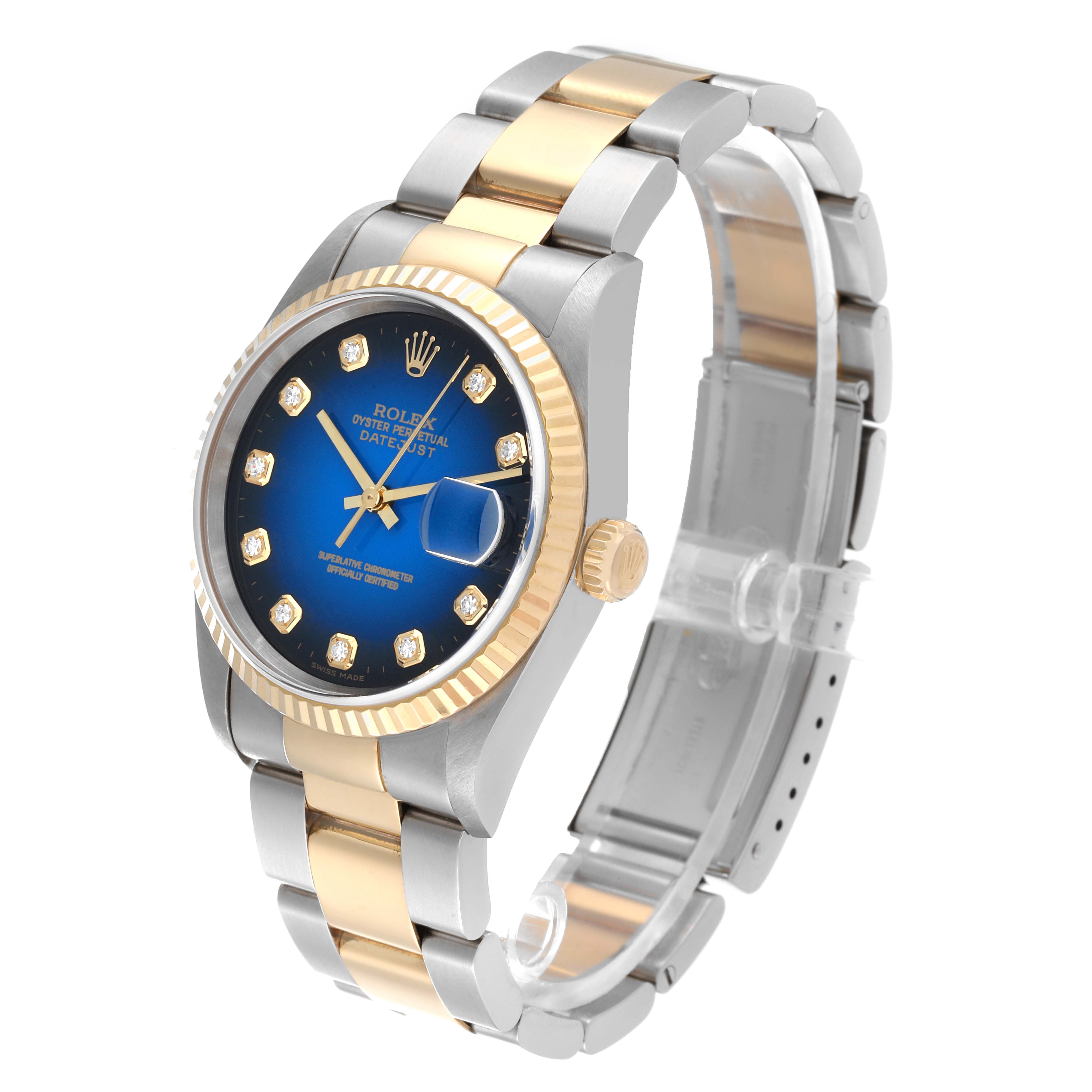 The image shows a Rolex Datejust 16233 Men's Steel and Gold (two tone) Blue Dial 16233 Men's Steel and Gold (two tone) Blue Dial watch at an angle displaying the face, crown, band, and clasp.