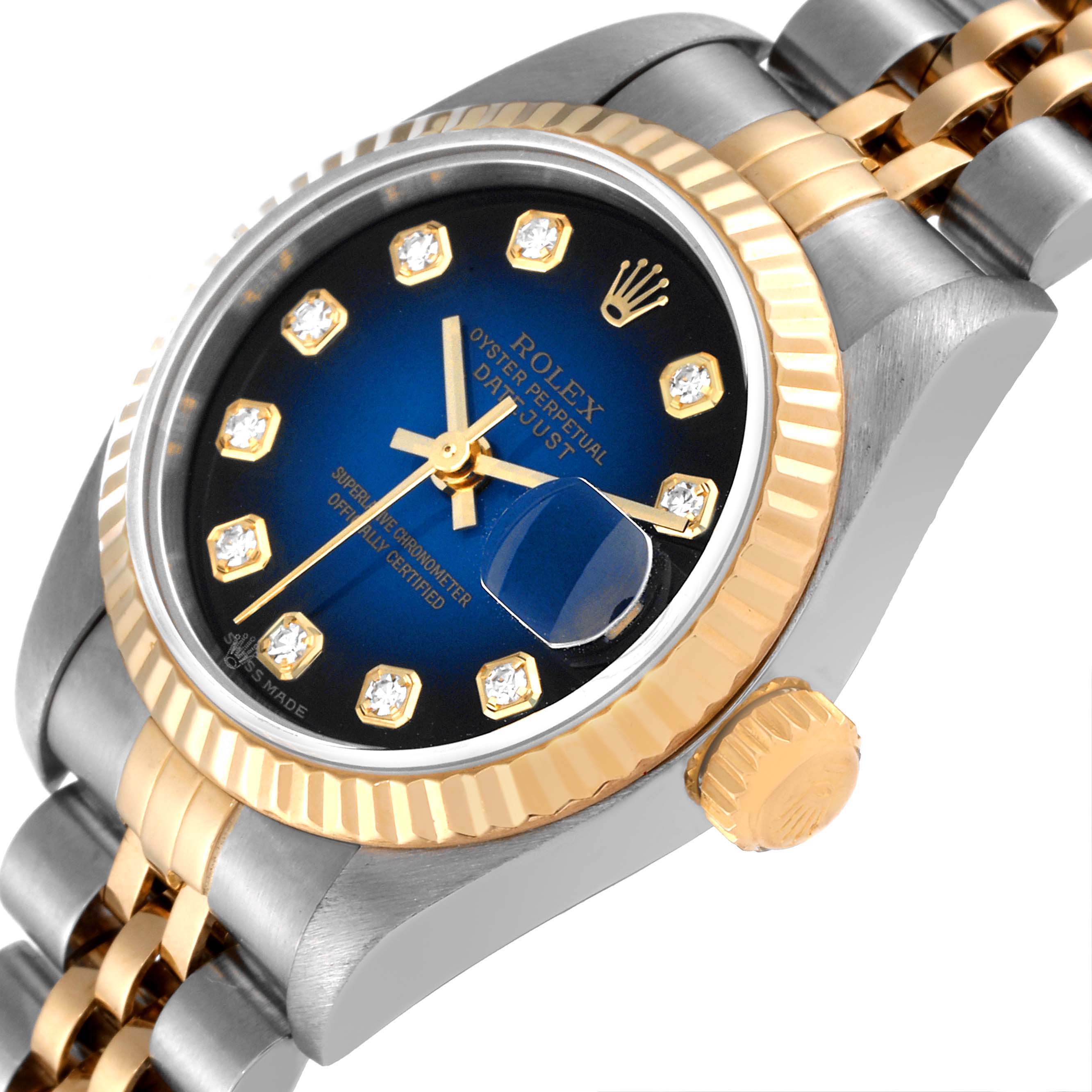 The image shows a close-up of the Rolex Datejust 79173 Women
s Steel and Gold (two tone) Blue Dial 79173 Women
s Steel and Gold (two tone) Blue Dial watch at an angle, highlighting the crown and fluted bezel.