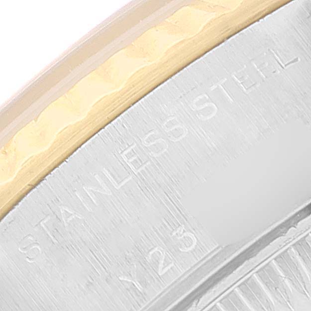 The image shows a close-up of the edge of the stainless steel and gold bezel of a Rolex Datejust 79173 Women
s Steel and Gold (two tone) Blue Dial 79173 Women
s Steel and Gold (two tone) Blue Dial watch.