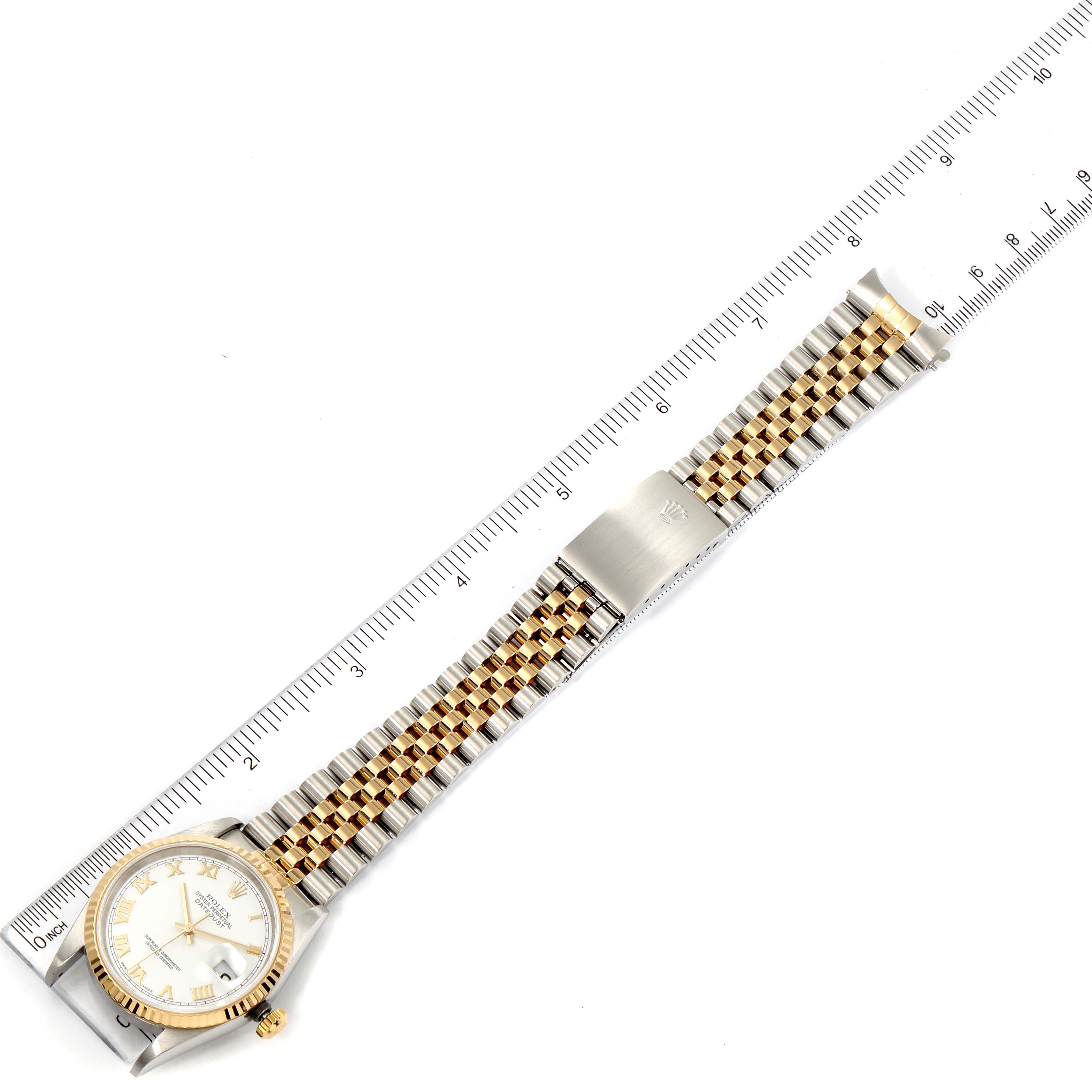 The image shows a top view of the Rolex Datejust 16233 Men's Steel and Gold (two tone) White Dial 16233 Men's Steel and Gold (two tone) White Dial watch, including the face, bracelet, and clasp, aligned with a measuring ruler.