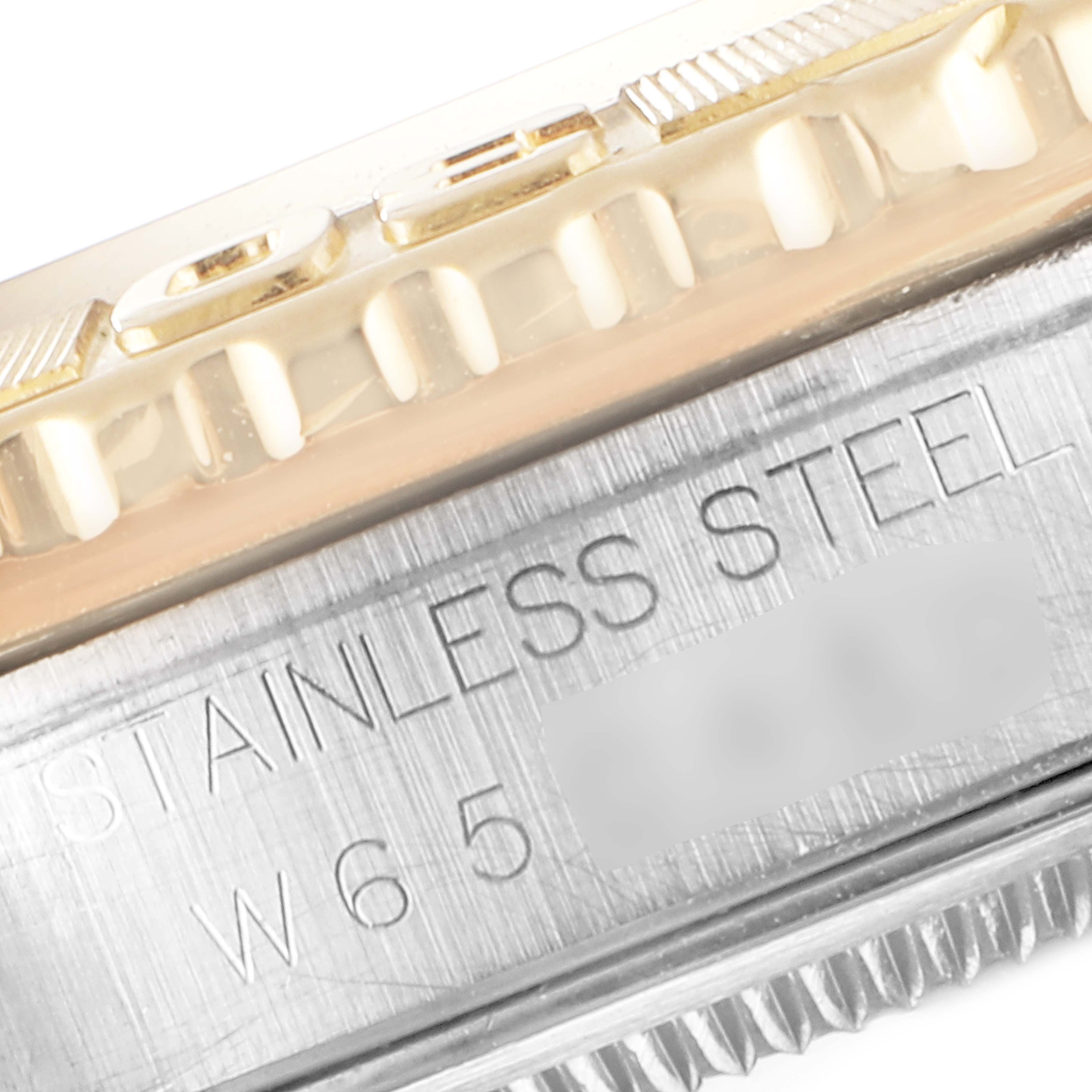 This image shows a close-up side view of a Rolex Turn-o-Graph 16263 Men's Steel and Gold (two tone) White Dial 16263 Men's Steel and Gold (two tone) White Dial watch, highlighting the bezel and case with "STAINLESS STEEL" engraving.