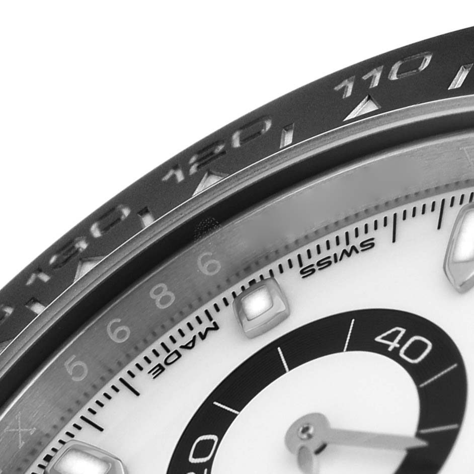 The image shows a close-up angle of the Rolex Daytona 116500 Men's Stainless Steel White Dial watch, focusing on the bezel and part of the dial.