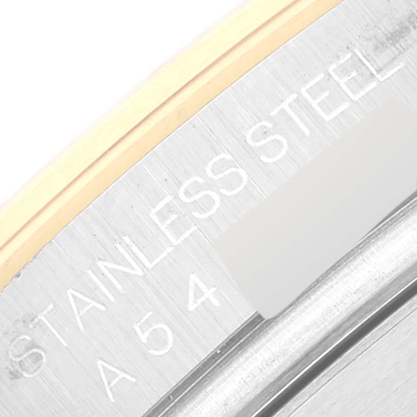 The image shows a close-up of the edge of the case back, inscriptions, and bezel of a Rolex Daytona 16523 Men
s Steel and Gold (two tone) White Dial 16523 Men
s Steel and Gold (two tone) White Dial watch.