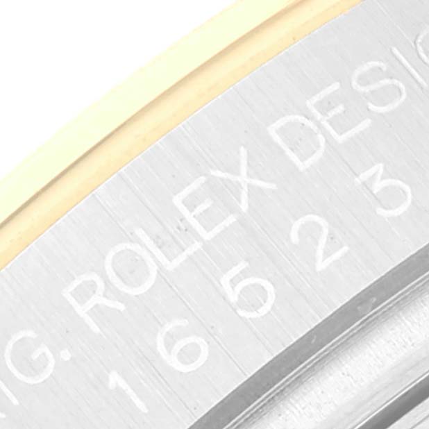 This close-up image shows the engraved side of the bezel of a Rolex Daytona 16523 Men
s Steel and Gold (two tone) White Dial 16523 Men
s Steel and Gold (two tone) White Dial watch.