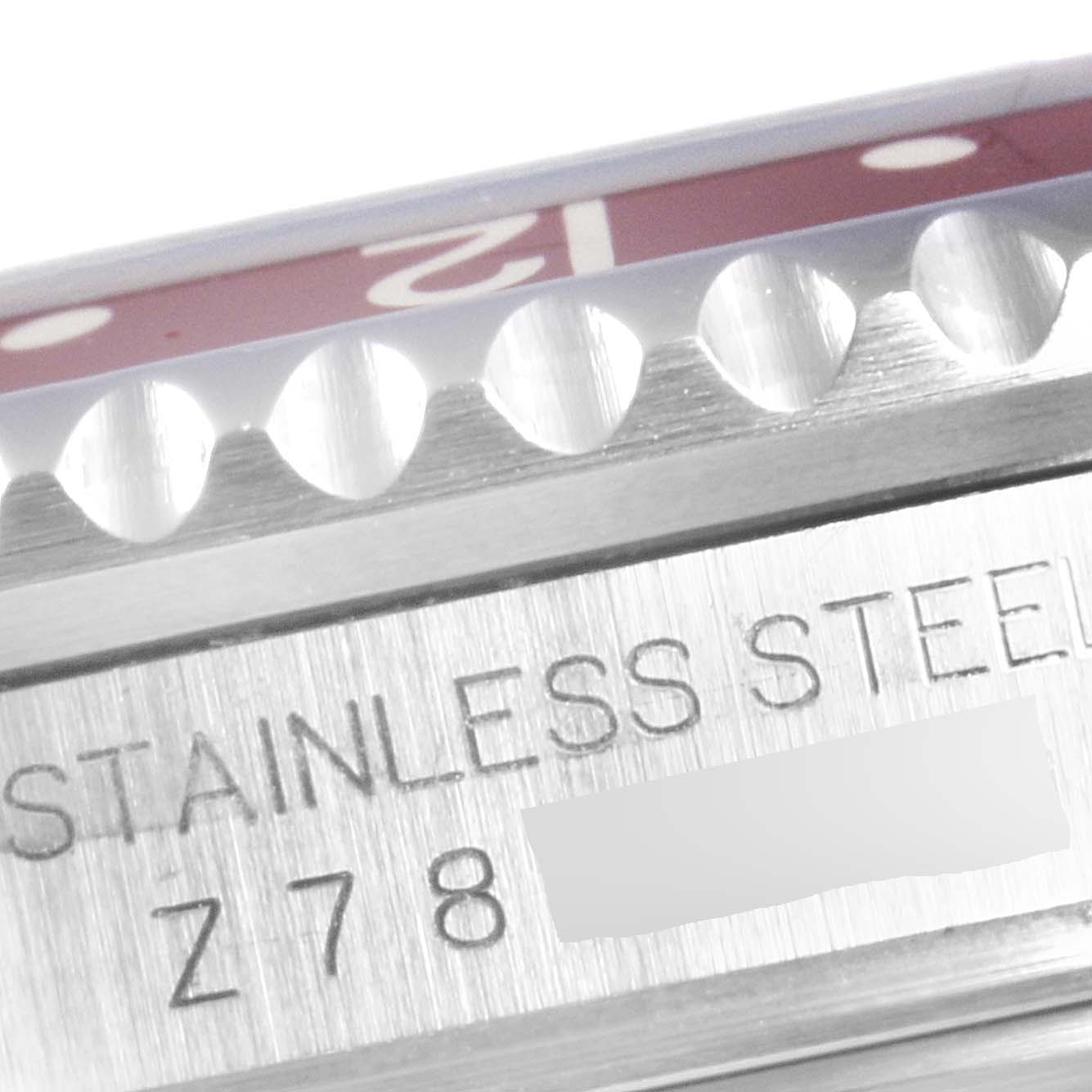 This close-up angle shows the stainless steel casing and partial red bezel of a Rolex GMT-Master 16710 Men's Stainless Steel Black Dial 16710 Men's Stainless Steel Black Dial watch.