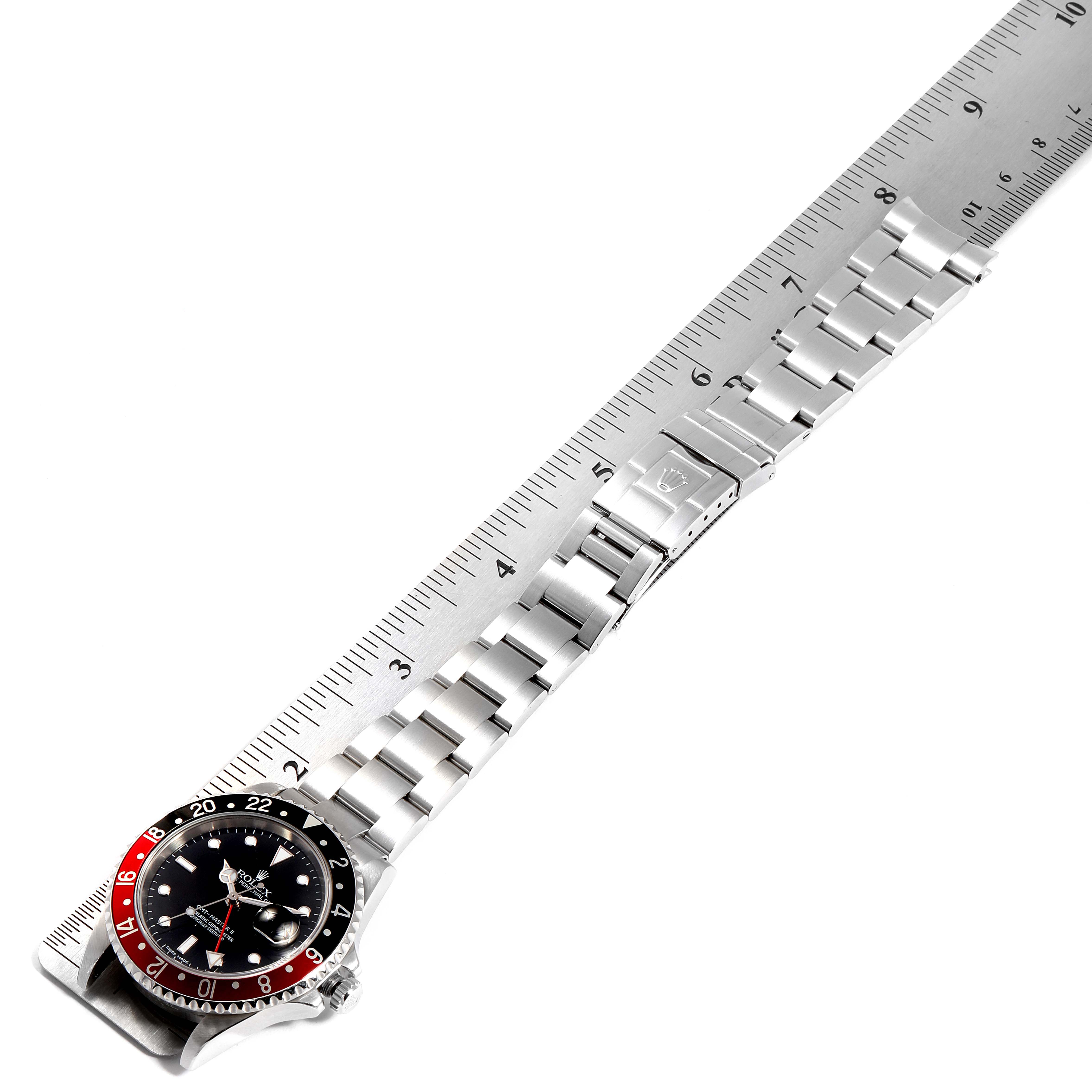 The image shows the Rolex GMT-Master 16710 Men's Stainless Steel Black Dial 16710 Men's Stainless Steel Black Dial watch laid flat with a metal ruler, displaying the face, bezel, and full bracelet.