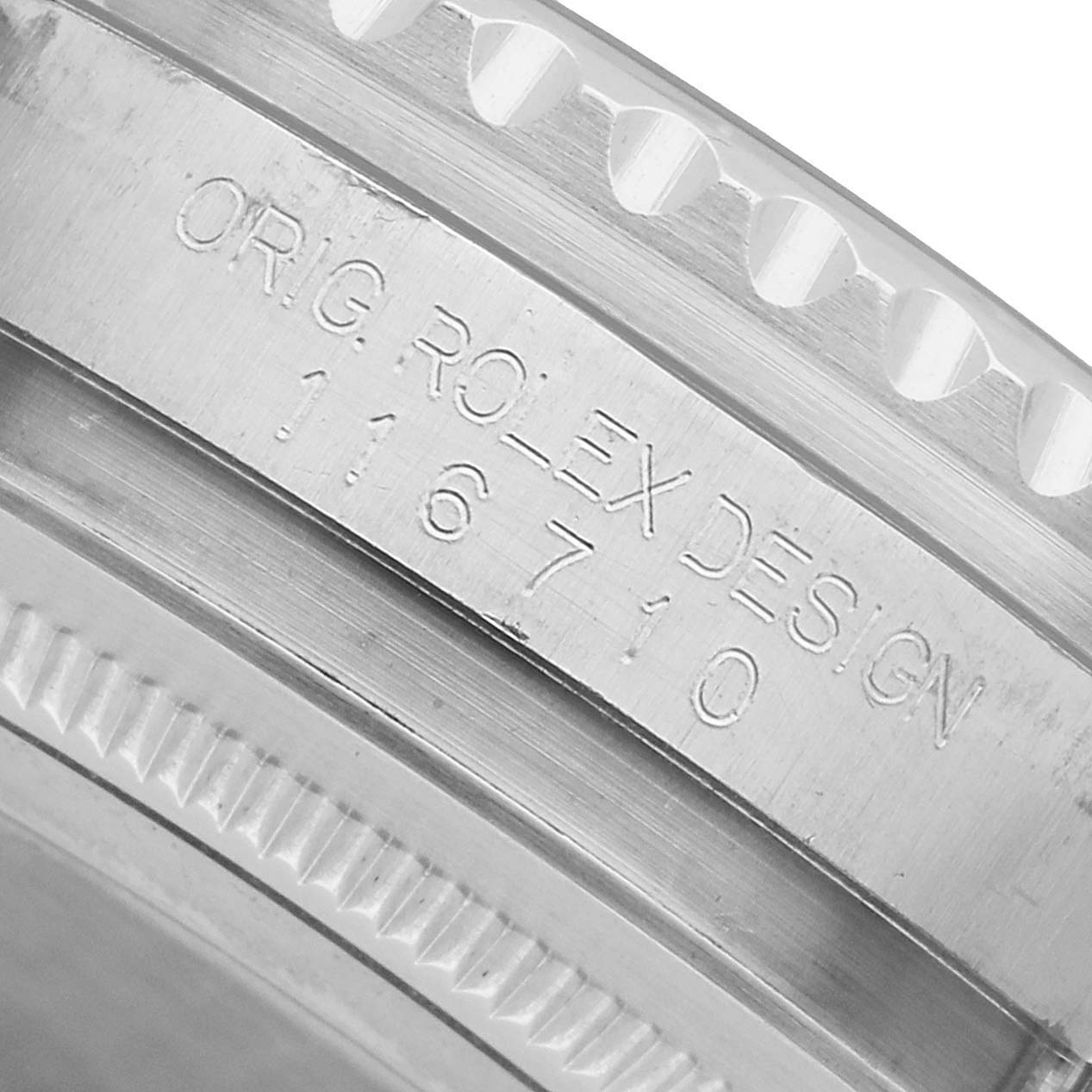The image shows an angled close-up of the case edge and engraved lettering on the Rolex GMT-Master 116710 Men's Stainless Steel Black Dial model, including the reference number.