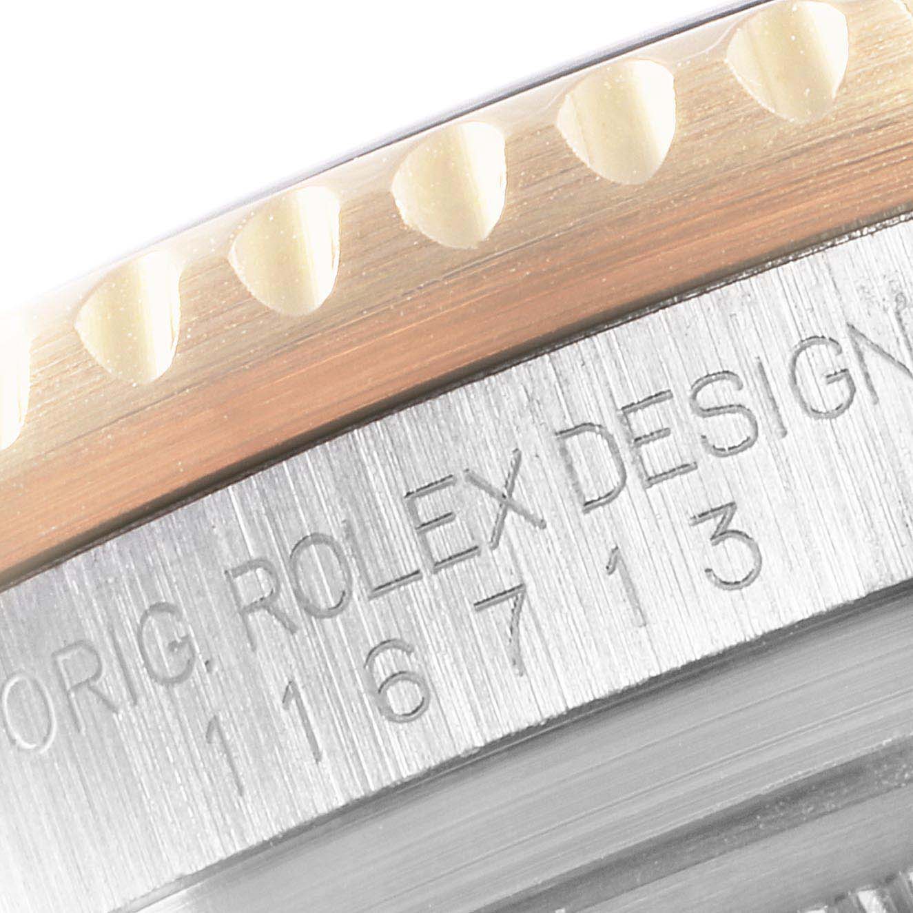 The image shows a close-up of the bezel and the case edge with engravings on a Rolex GMT-Master 116713 Men's Steel and Gold (two tone) Black Dial 116713 Men's Steel and Gold (two tone) Black Dial model watch.