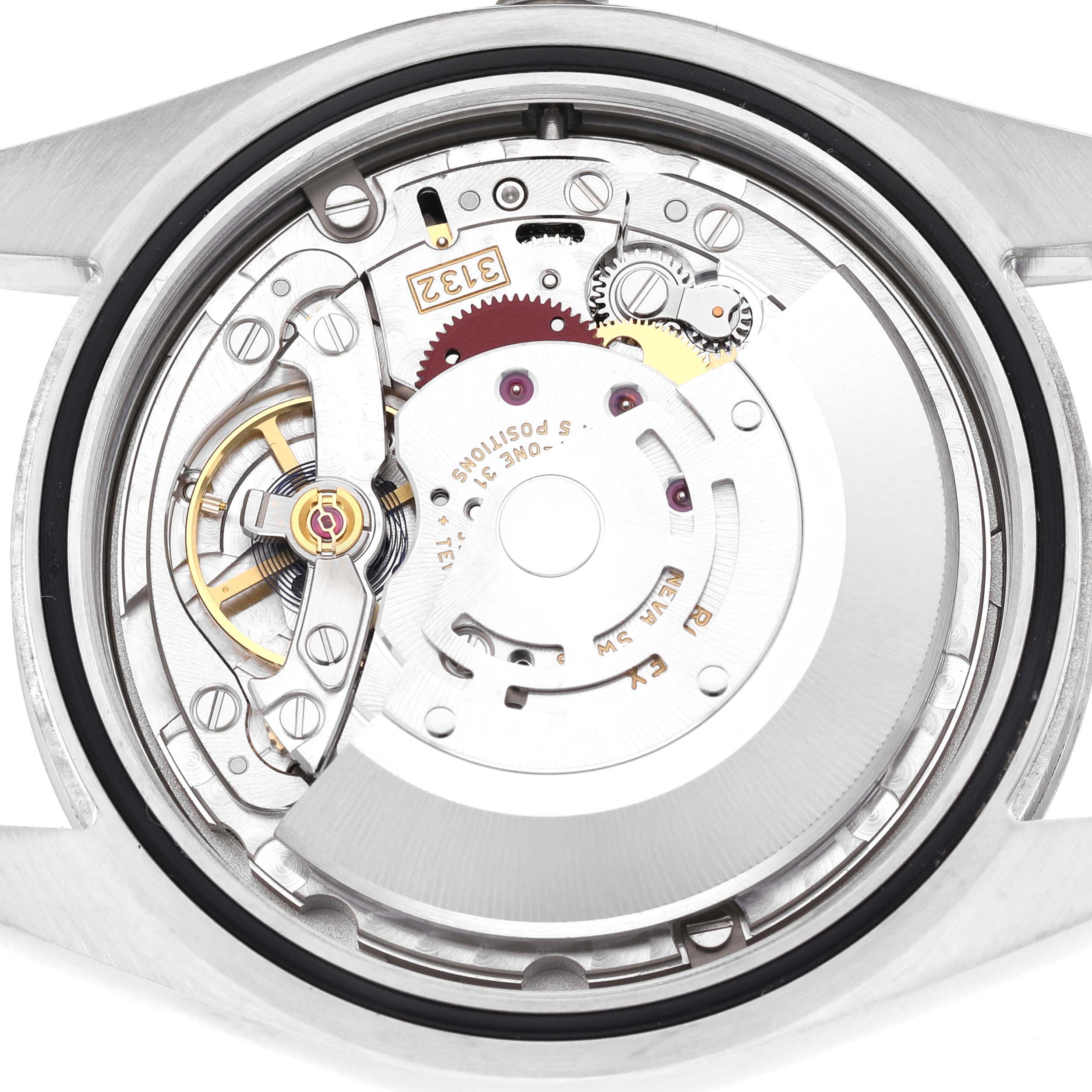 The image shows the back view of a Rolex Oyster Perpetual 114300 Men's Stainless Steel Grey Dial, highlighting its intricate movement mechanism.
