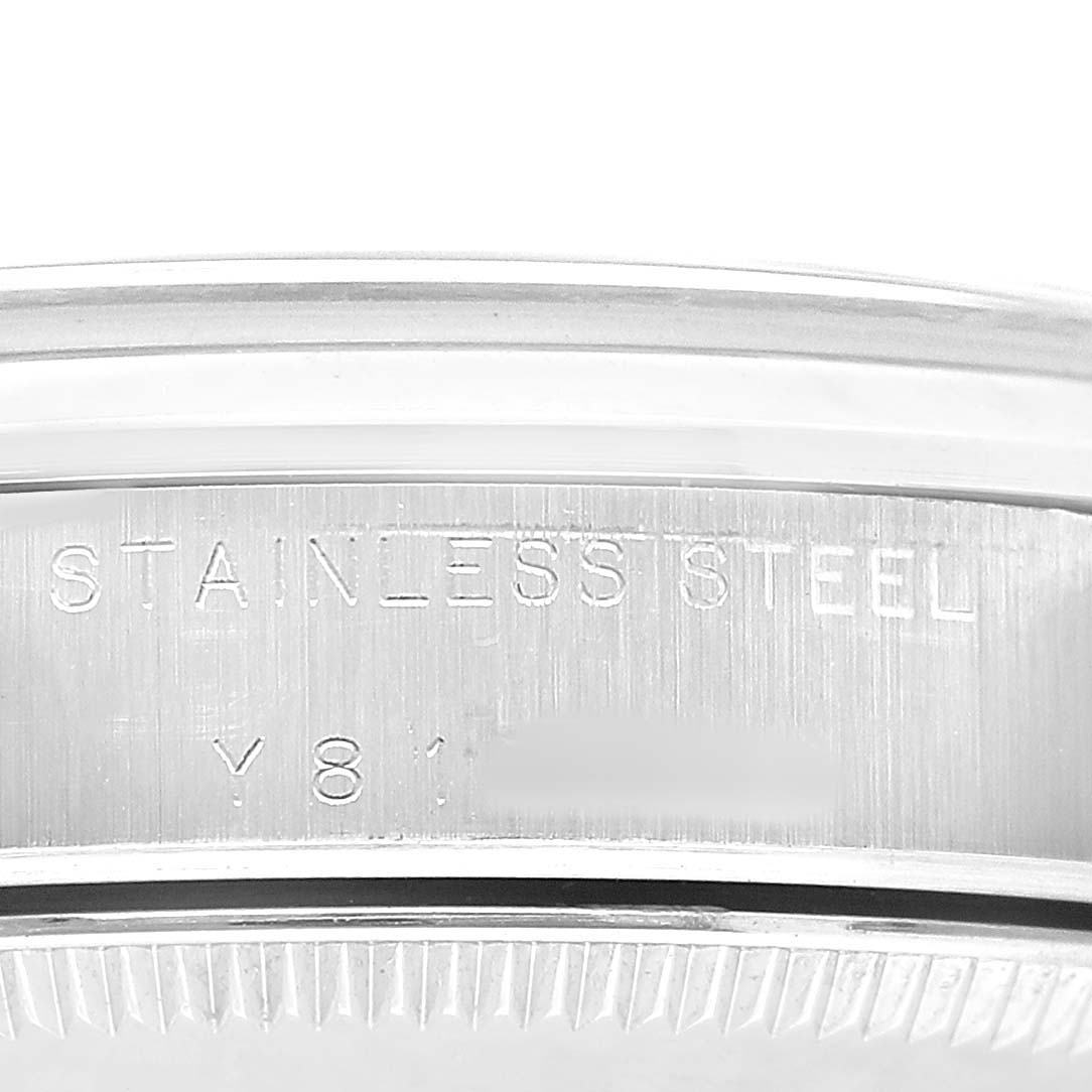 The image shows the side engraving on a stainless steel case of a Rolex Mid-Size 77080 Women's Stainless Steel Black Dial watch, focusing on text detail.