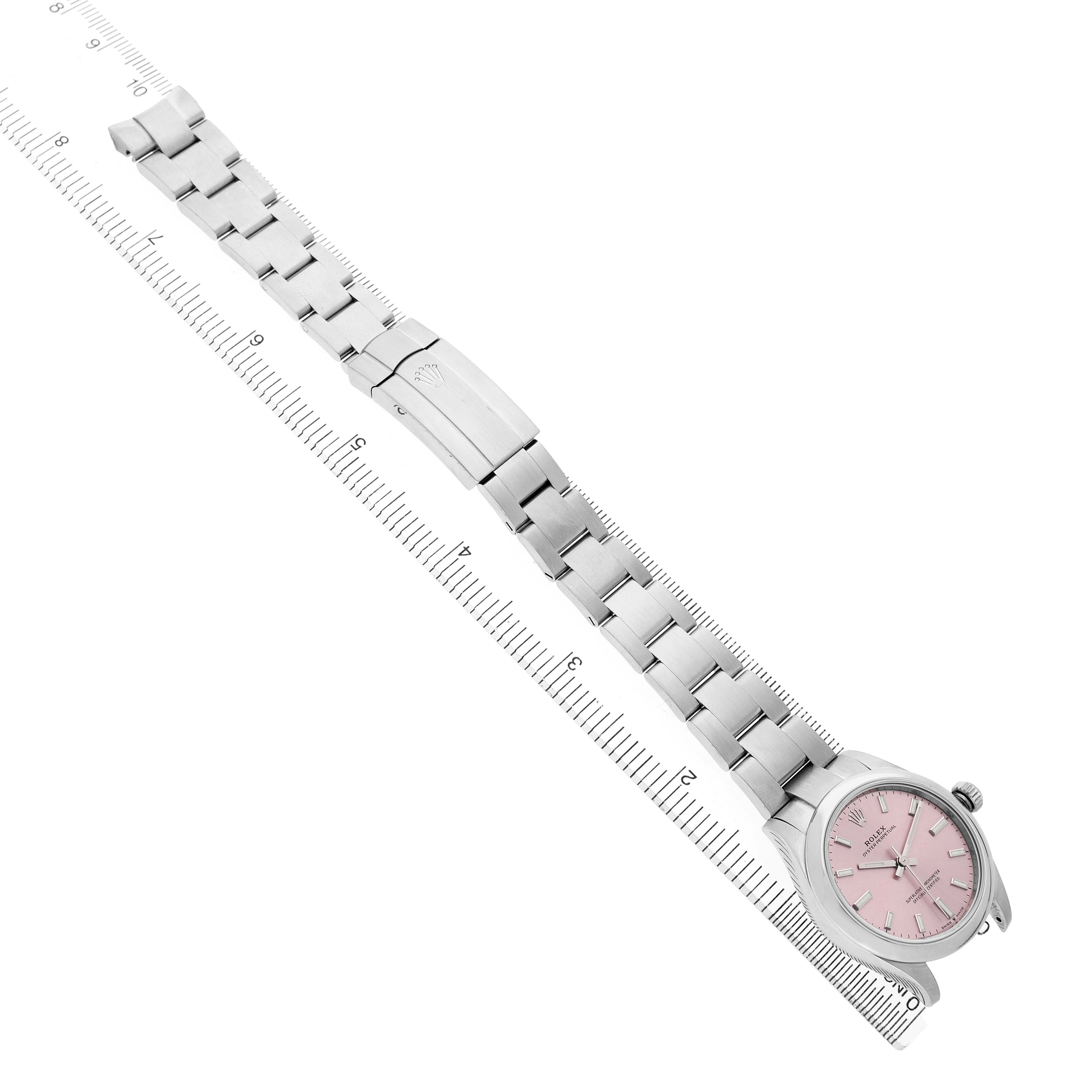 The Rolex Mid-Size 277200 Women's Stainless Steel Pink Dial watch is shown from a top angle, highlighting the pink dial, stainless steel bracelet, and clasp.