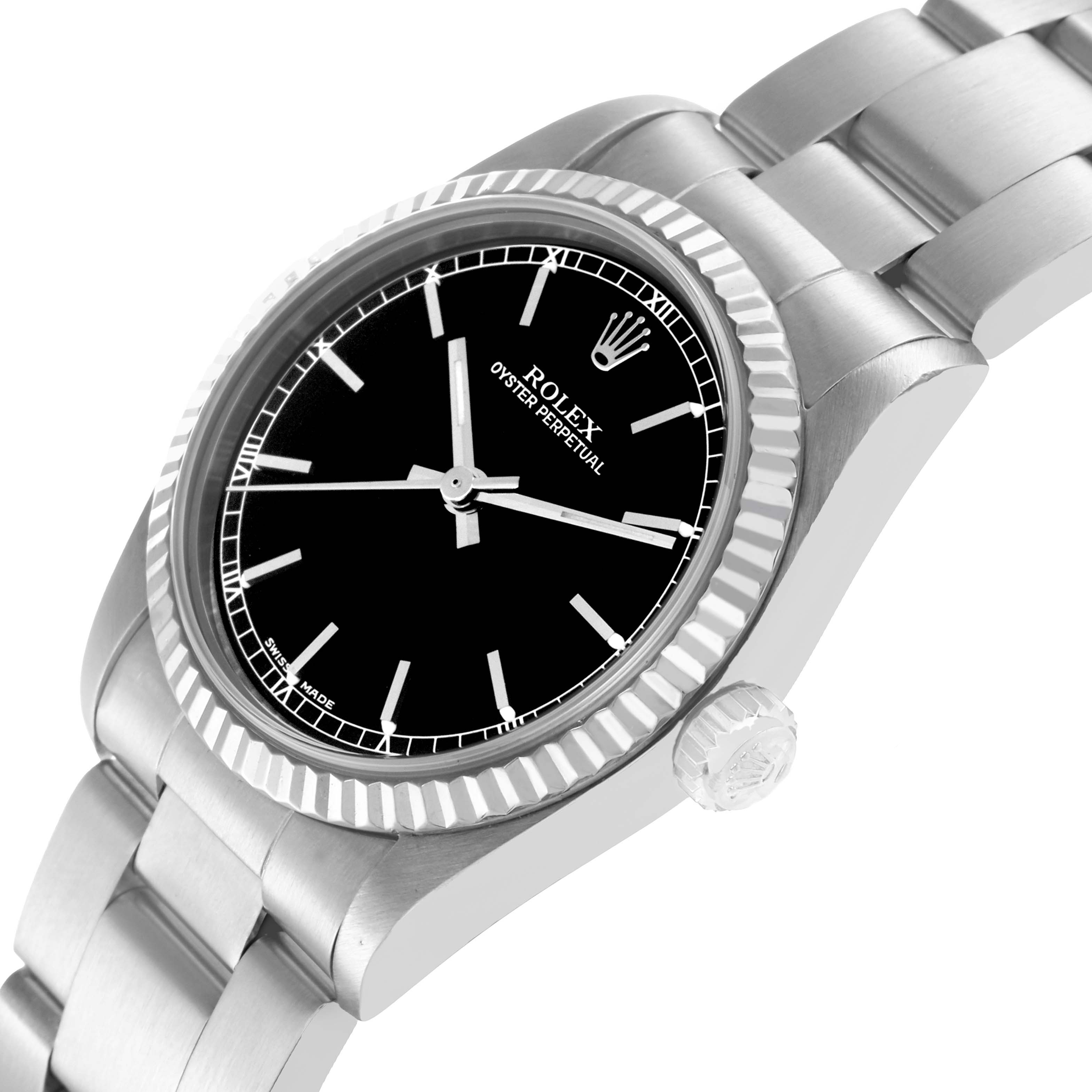 The Rolex Oyster Perpetual 77014 Women
s Stainless Steel Black Dial watch is shown at an angled side view, displaying its bezel, crown, bracelet, and black dial.