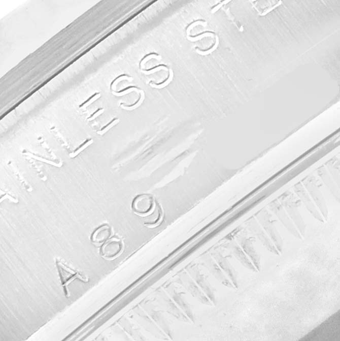 The image shows a close-up of the engraving on the stainless steel casing of a Rolex Oyster Perpetual 77014 Women
s Stainless Steel Black Dial watch.