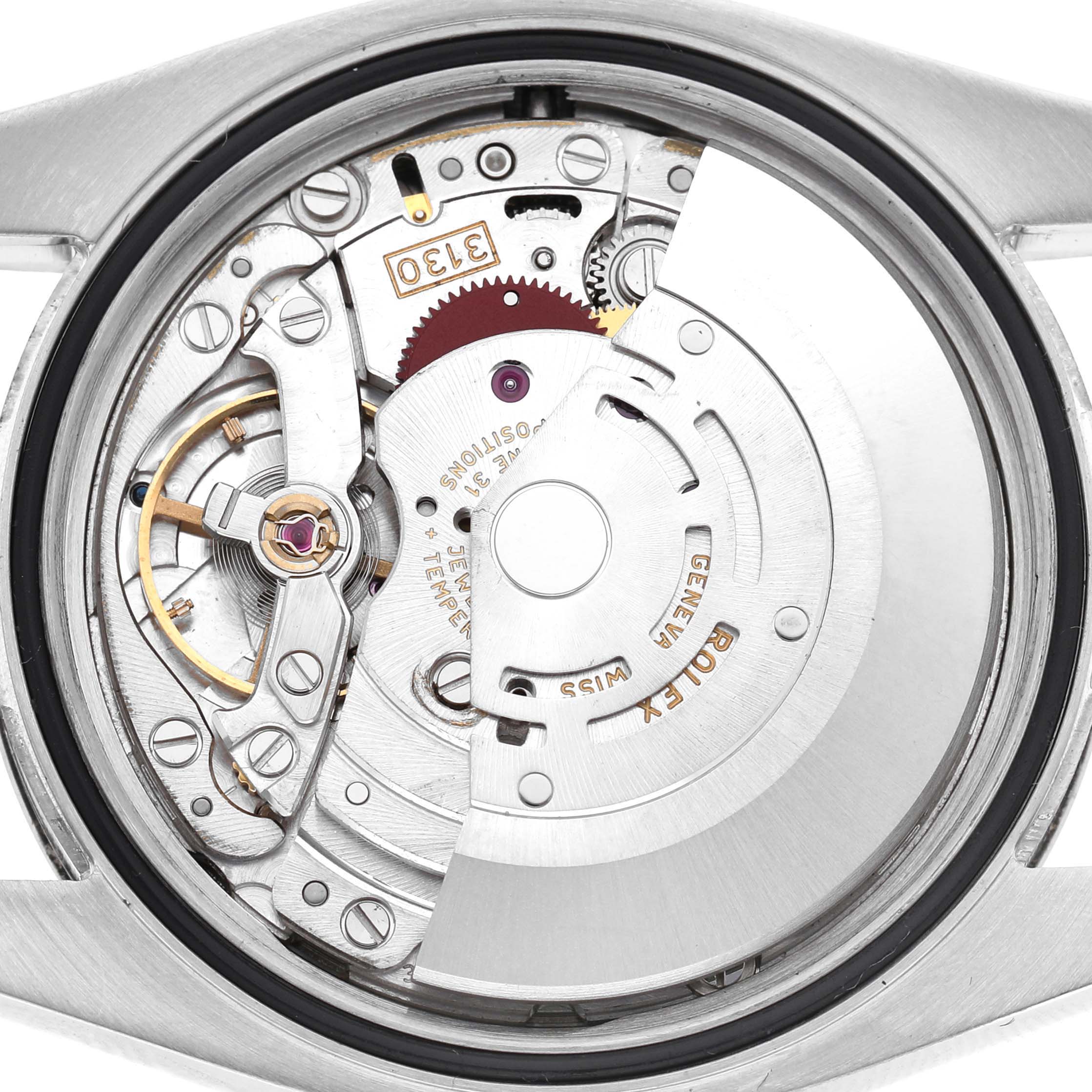 The image shows the internal movement of a Rolex Oyster Perpetual 116034 Men's Stainless Steel Silver Dial watch from a top-down angle.