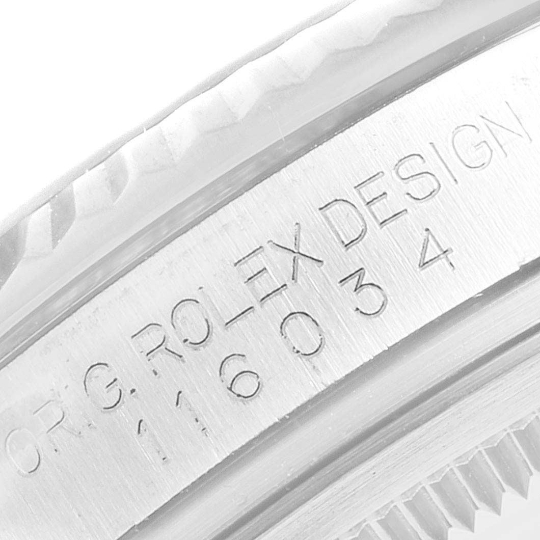 The image shows a close-up of the engraving on the flange of a Rolex Oyster Perpetual 116034 Men's Stainless Steel Silver Dial watch.