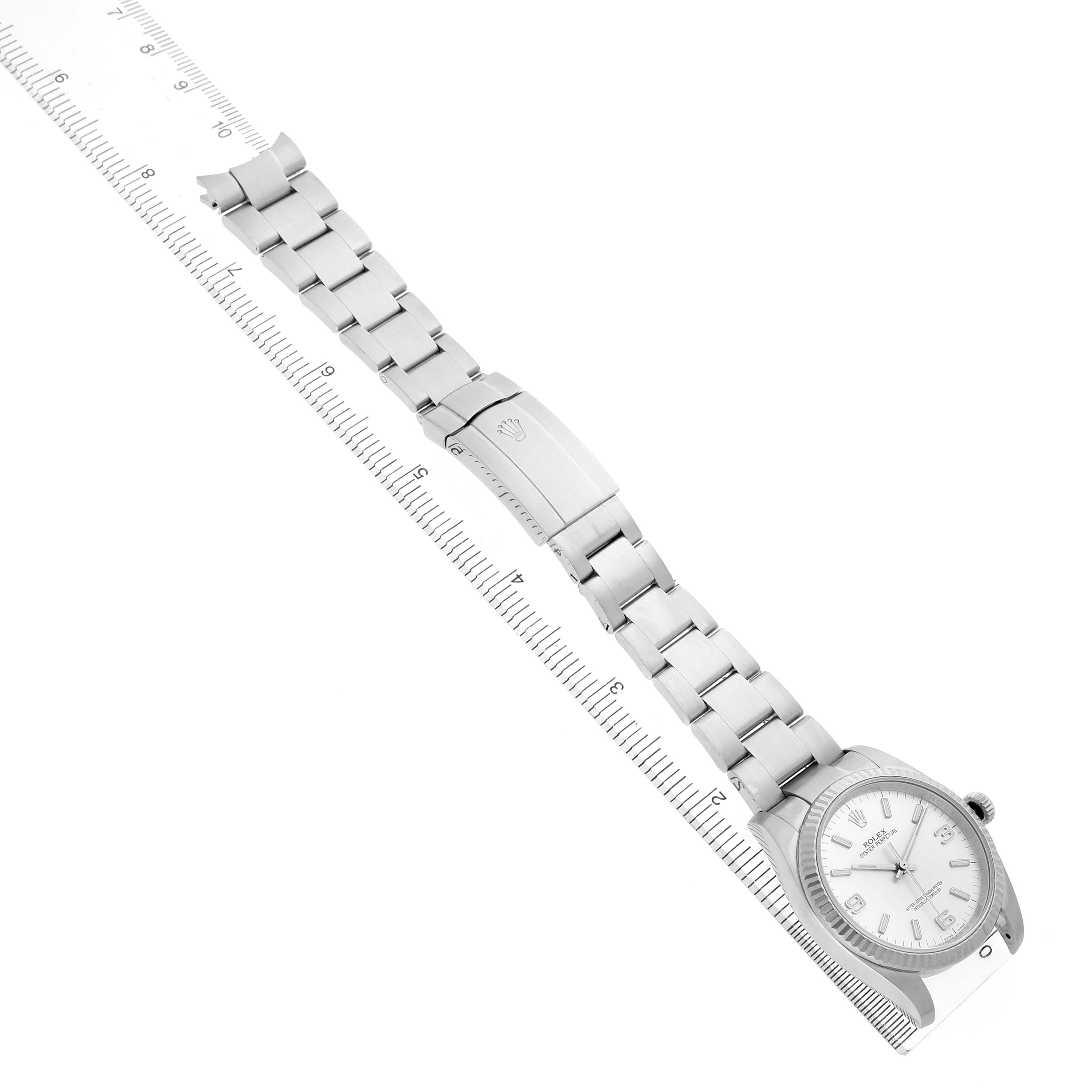 The Rolex Oyster Perpetual 116034 Men's Stainless Steel Silver Dial watch is shown at a slight angle, displaying the full bracelet and face alongside a ruler for scale.