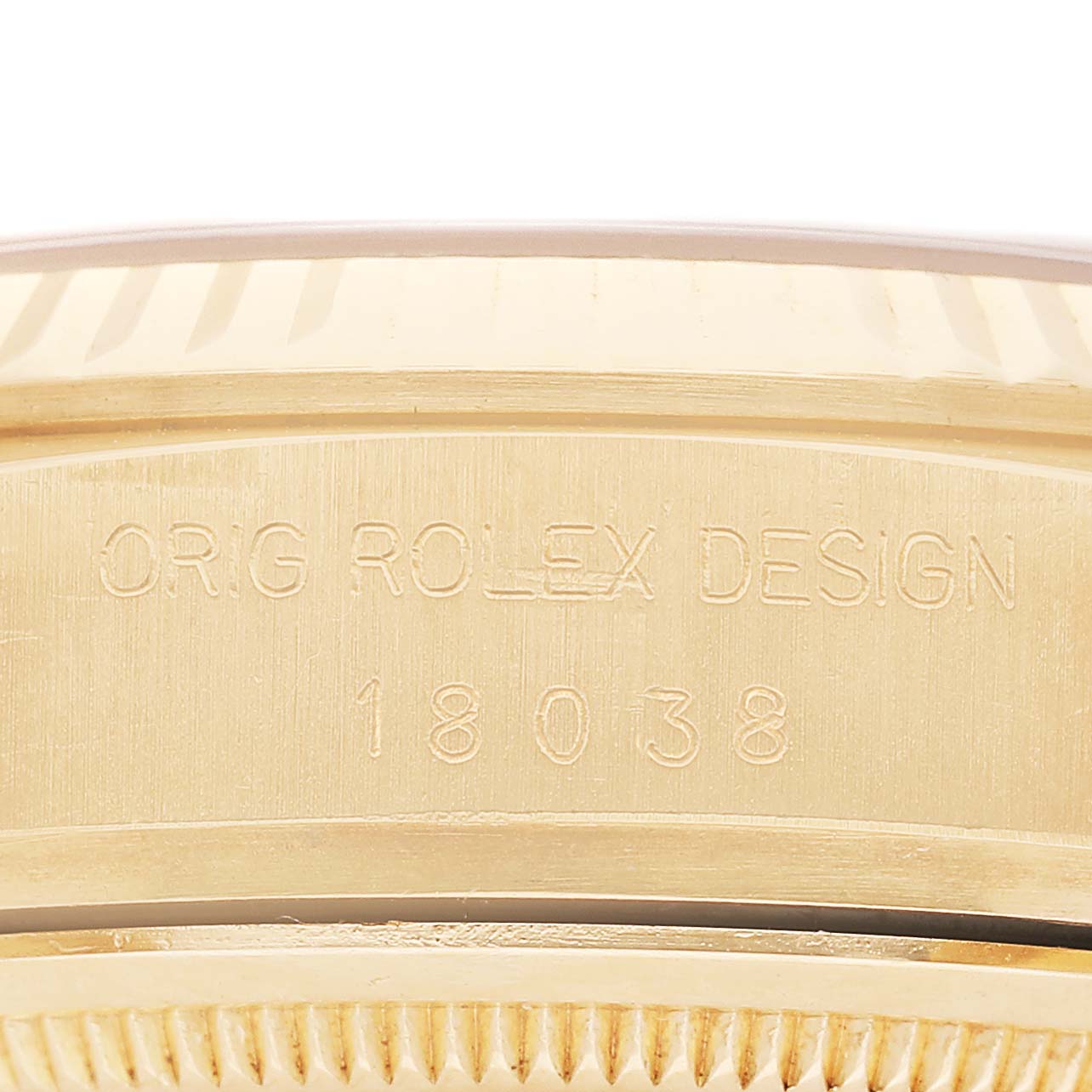 The image shows a close-up of the side case and fluted bezel with engraved markings of a Rolex President 18038 Men's Yellow Gold Champagne Dial watch.