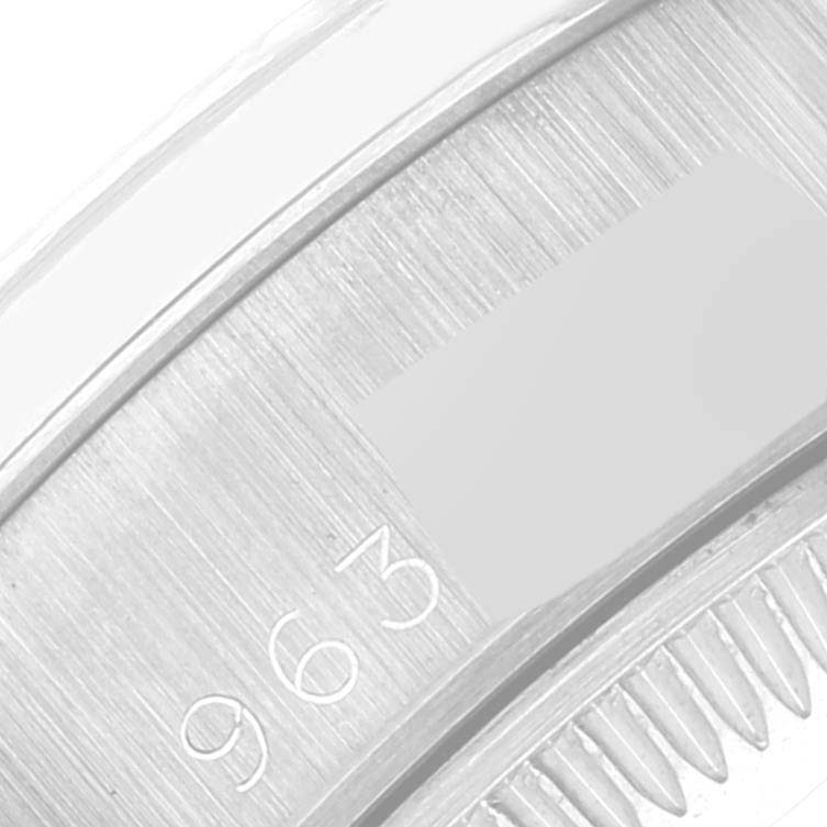 This image shows a close-up of the President model by Rolex, focusing on the caseback with visible serial numbers.