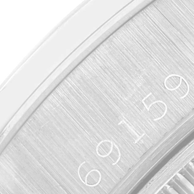 This close-up image shows the engraved serial number on the side of a Rolex President 69159 Women's Steel and Gold (two tone) Champagne Dial 69159 Women's Steel and Gold (two tone) Champagne Dial watch case.