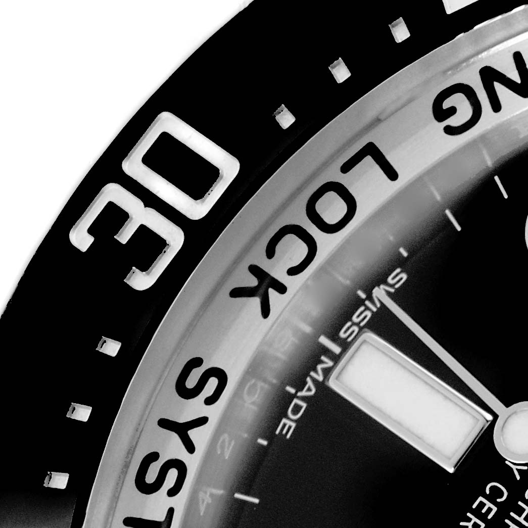 The image shows a close-up of the Rolex Sea-Dweller 116660 Men
s Stainless Steel Blue Dial
s bezel and part of the watch face, focusing on the 30-minute marker.