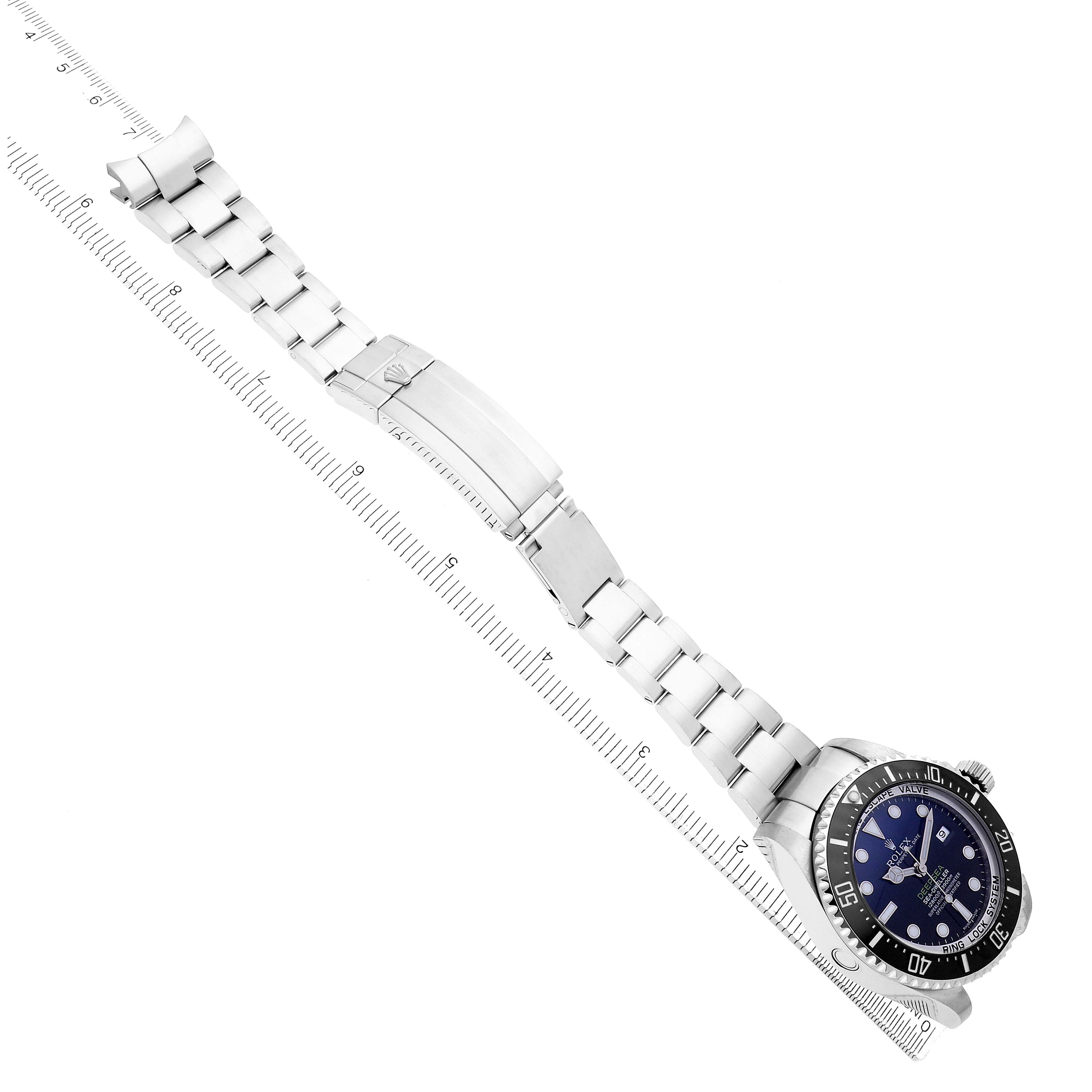 The Rolex Sea-Dweller 116660 Men
s Stainless Steel Blue Dial is shown from a side angle with the bracelet fully extended and clasp open, alongside a ruler.