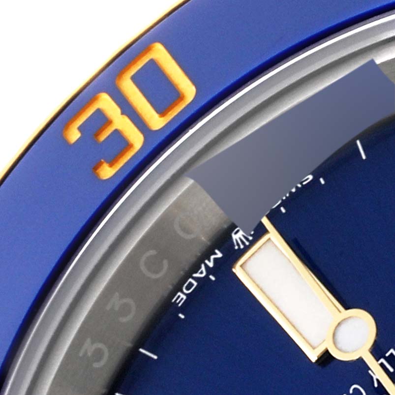 This close-up image shows the dial and bezel of the Rolex Submariner 126613 Men's Steel and Gold (two tone) Blue Dial 126613 Men's Steel and Gold (two tone) Blue Dial, highlighting the "30" marking and part of the minute hand.