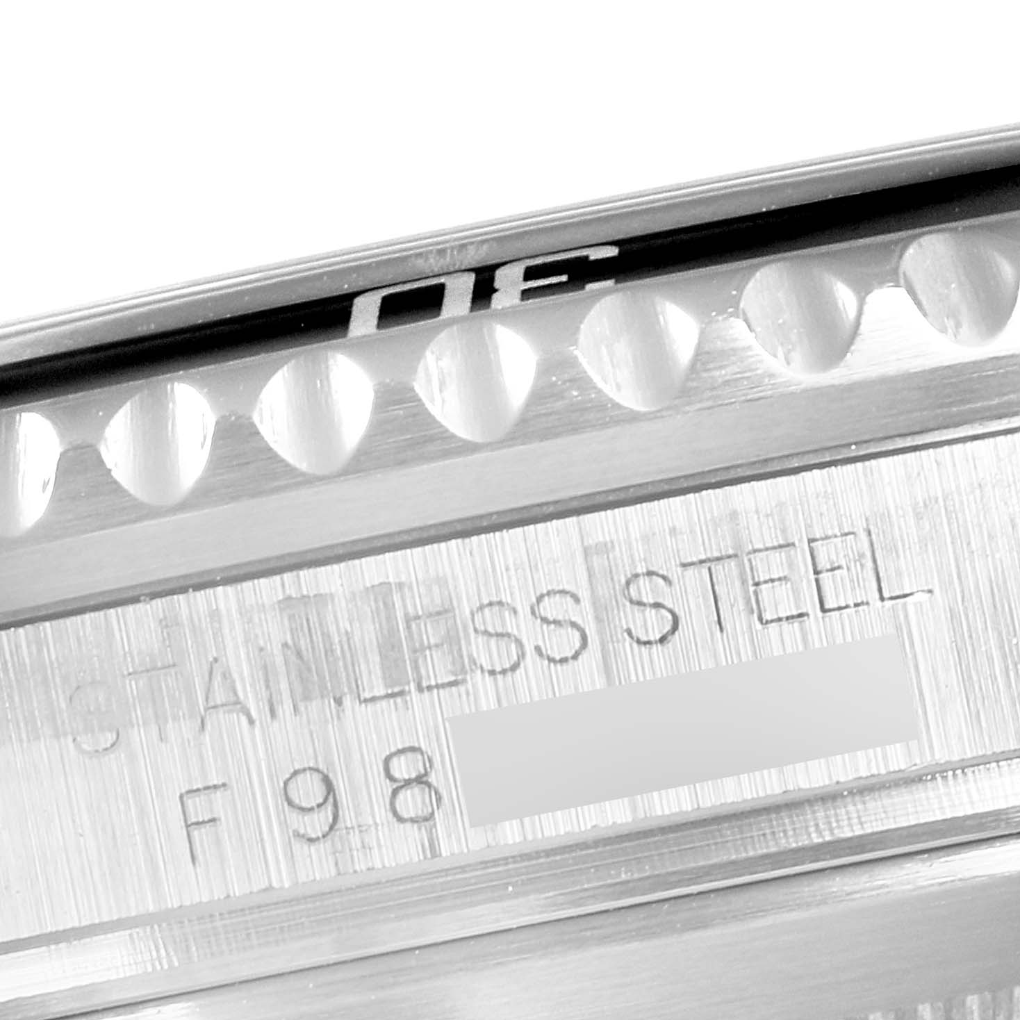 This close-up image shows the edge of the bezel and part of the stainless steel casing of a Rolex Submariner 16610 Men
s Stainless Steel Black Dial 16610 Men
s Stainless Steel Black Dial watch.