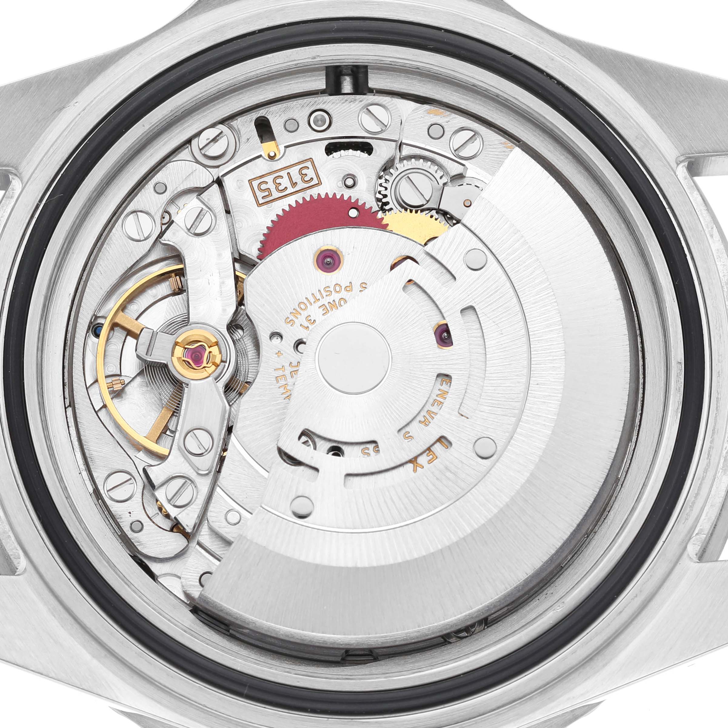 The image shows the internal mechanical movement of the Rolex Submariner 16610 Men's Stainless Steel Black Dial watch viewed from the back, highlighting gears and components.