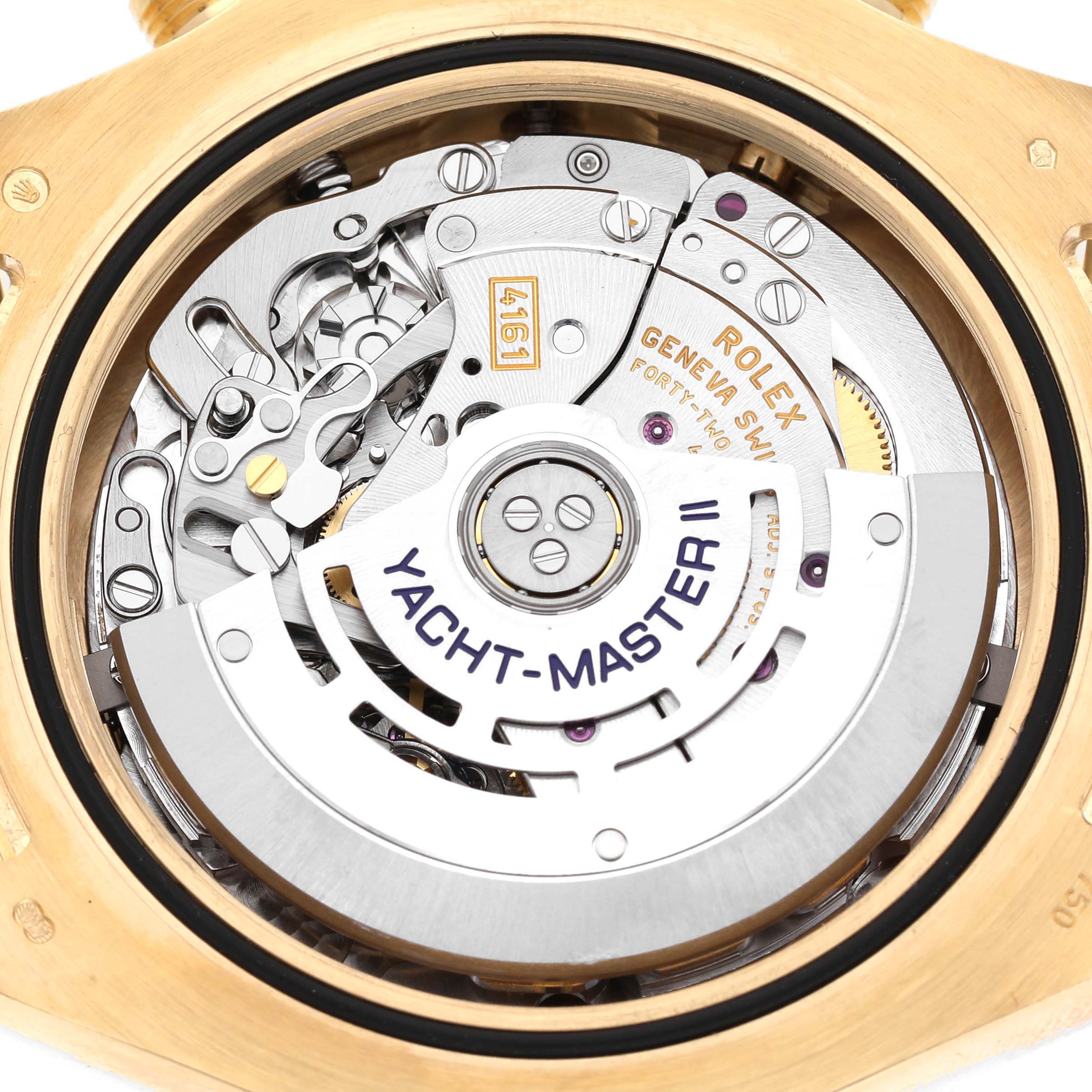 The image shows the movement and inner mechanism of the Rolex Yacht-Master 116688 Men's Yellow Gold White Dial II from a rear angle, highlighting its intricate components.