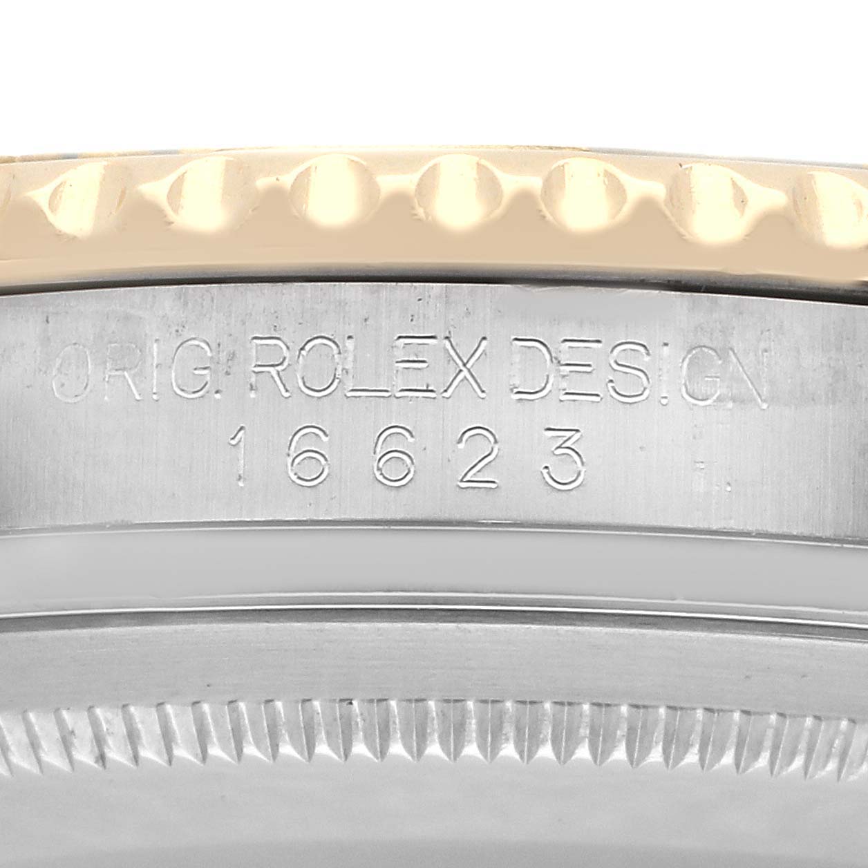 The image shows a close-up of the Rolex Yacht-Master 16623 Men
s Steel and Gold (two tone) Mother of Pearl Dial
s case side, focusing on the engravings.