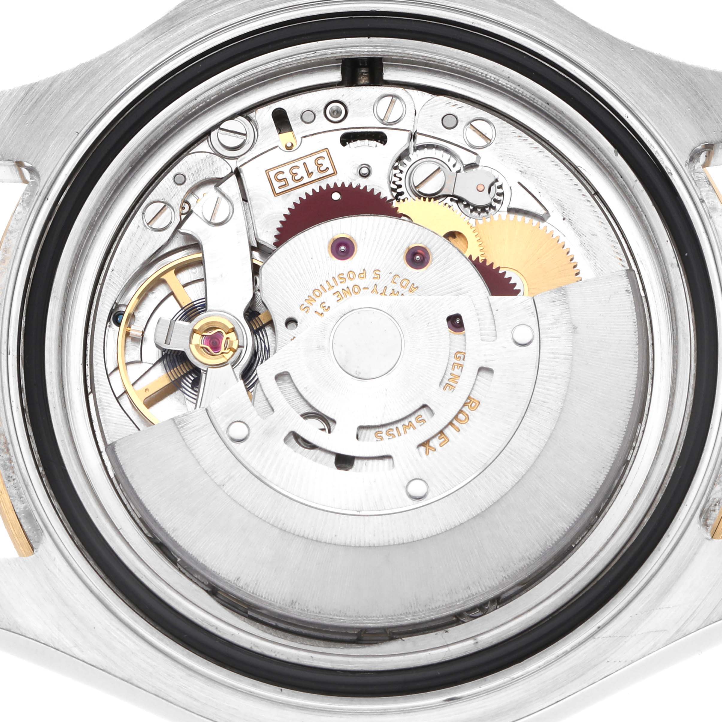 The image shows the internal mechanism of a Rolex Yacht-Master 16623 Men
s Steel and Gold (two tone) Mother of Pearl Dial watch from a back angle, highlighting its intricate components.