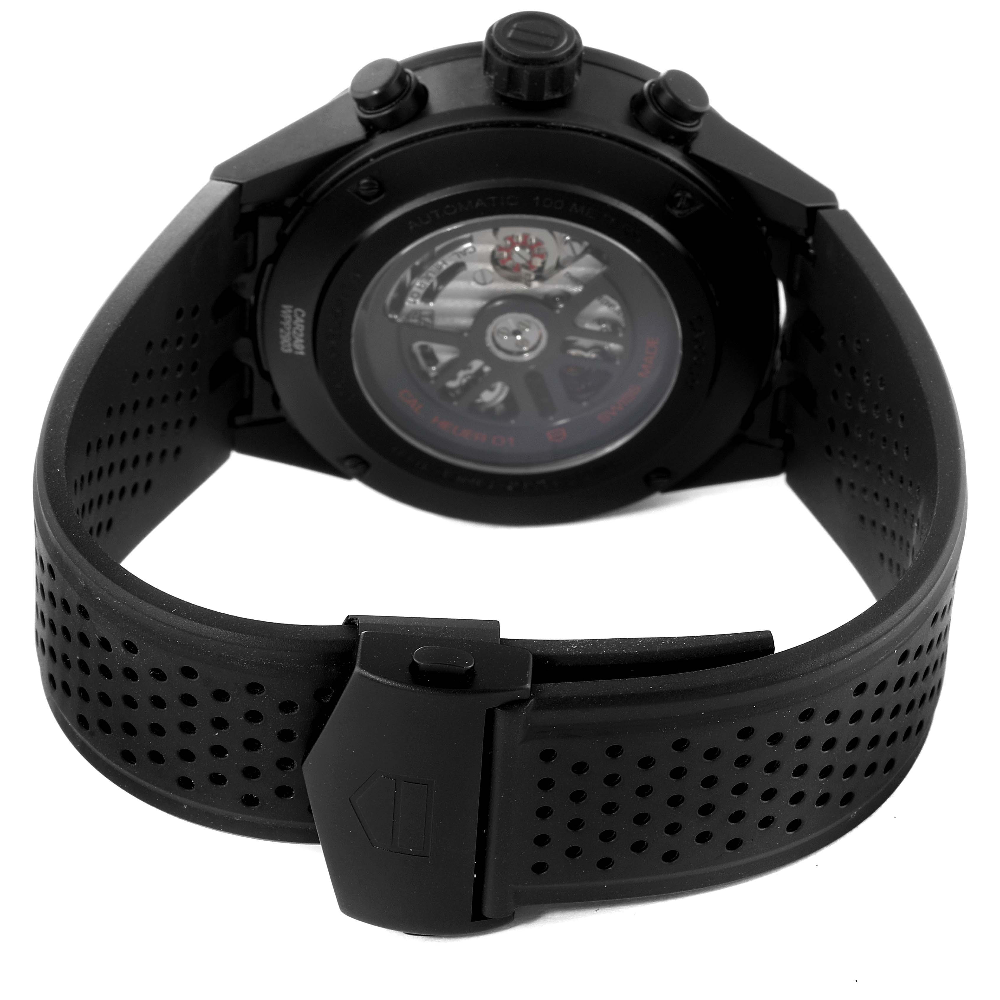 The image shows the back of a Tag Heuer Carrera CAR2A91.BH0742 Men's Ceramic Black Dial CAR2A91.BH0742 Men's Ceramic Black Dial watch, focusing on the see-through case back and the black perforated strap with a clasp.