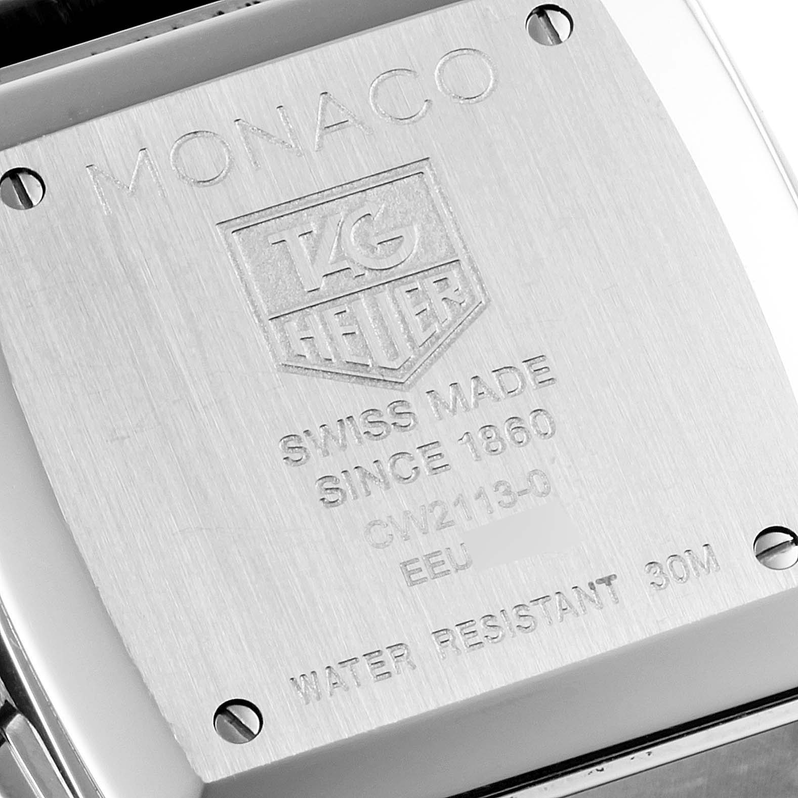 The image shows the back case of a Tag Heuer Monaco CW2113 Men
s Stainless Steel Blue Dial CW2113 Men
s Stainless Steel Blue Dial watch, displaying brand engravings and model details.