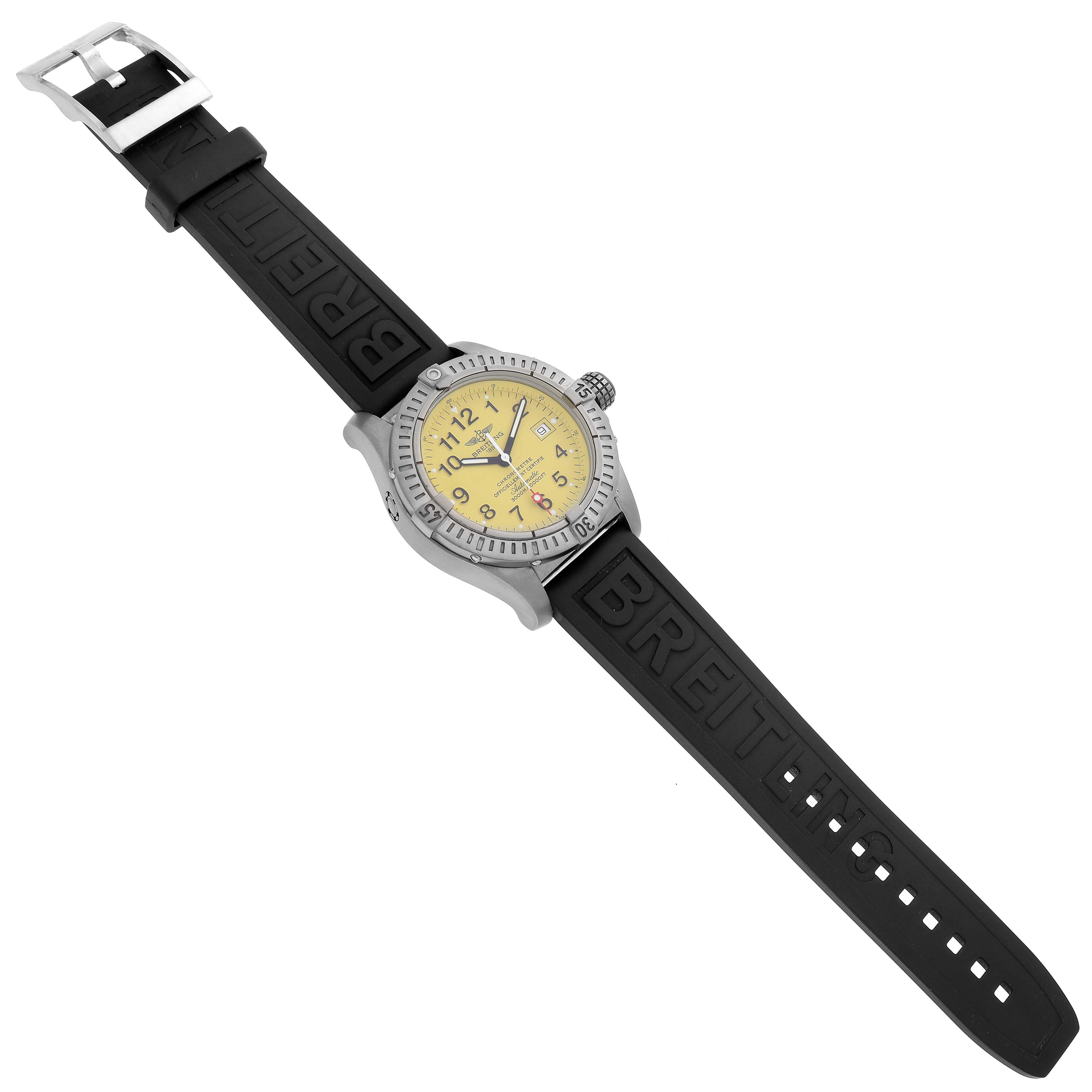 The Breitling Avenger E17370 Men
s Titanium Yellow Dial watch is shown from a top-down angle, featuring its face, bezel, and black strap with a visible buckle.