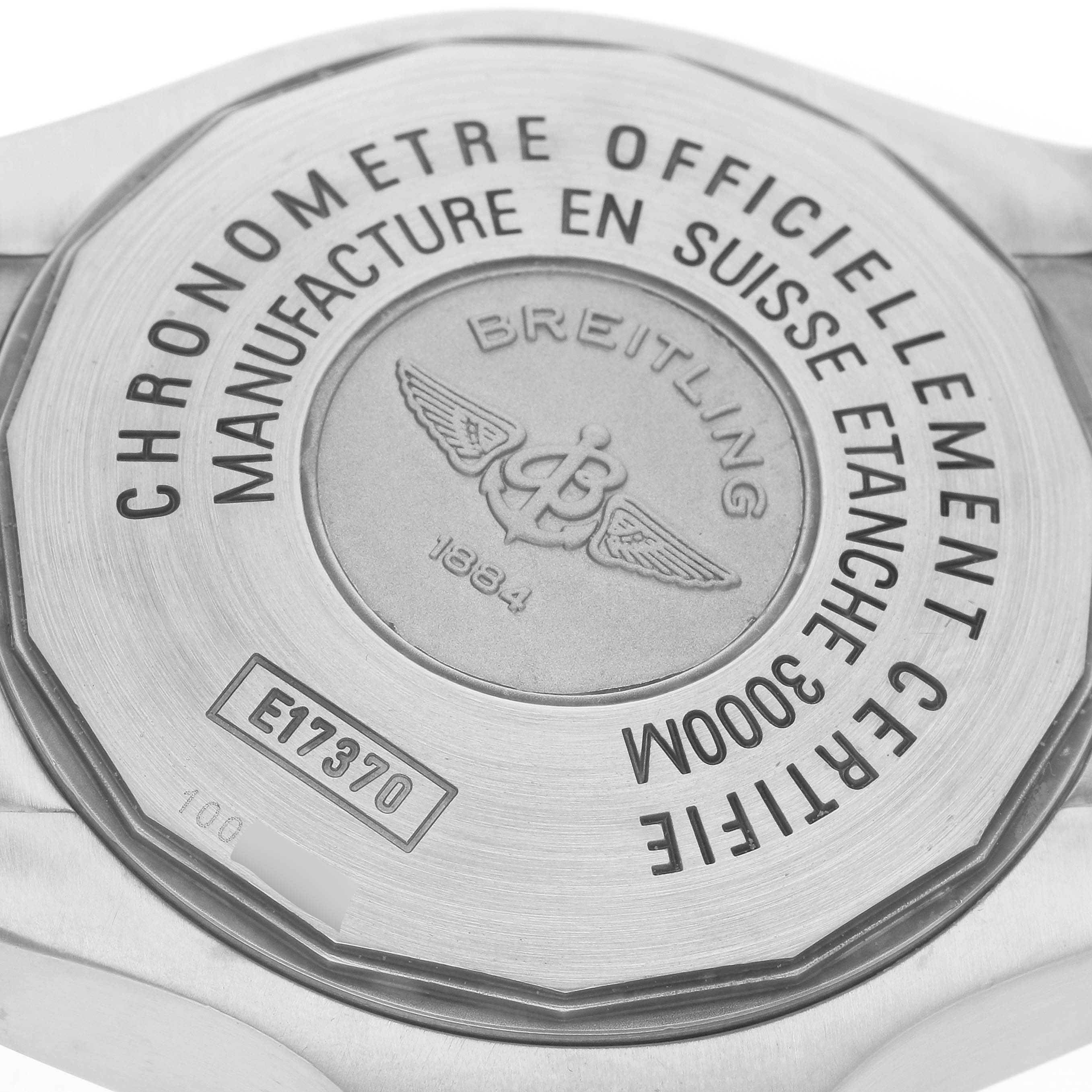 The image shows the case back of a Breitling Avenger E17370 Men
s Titanium Yellow Dial watch, highlighting engravings and logos.